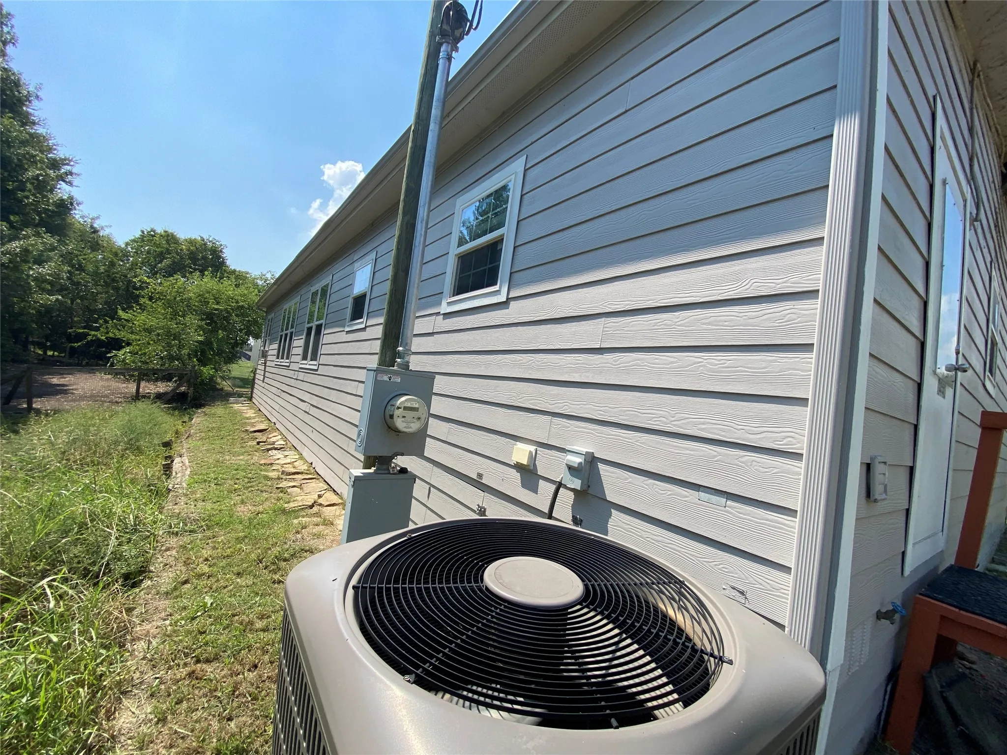 View of side of property with a central air condition unit