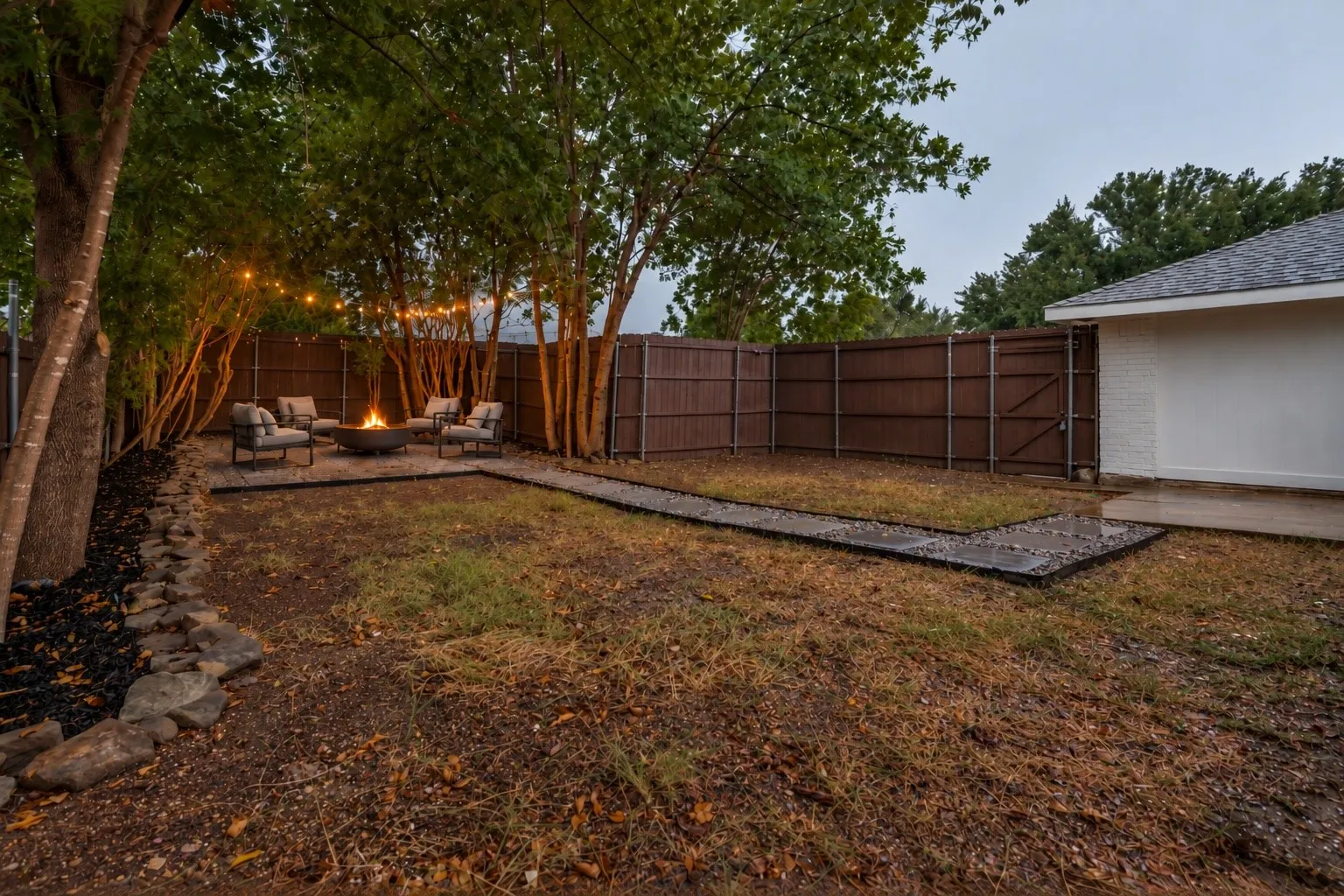 Backyard with virtually staged fire pit and chairs