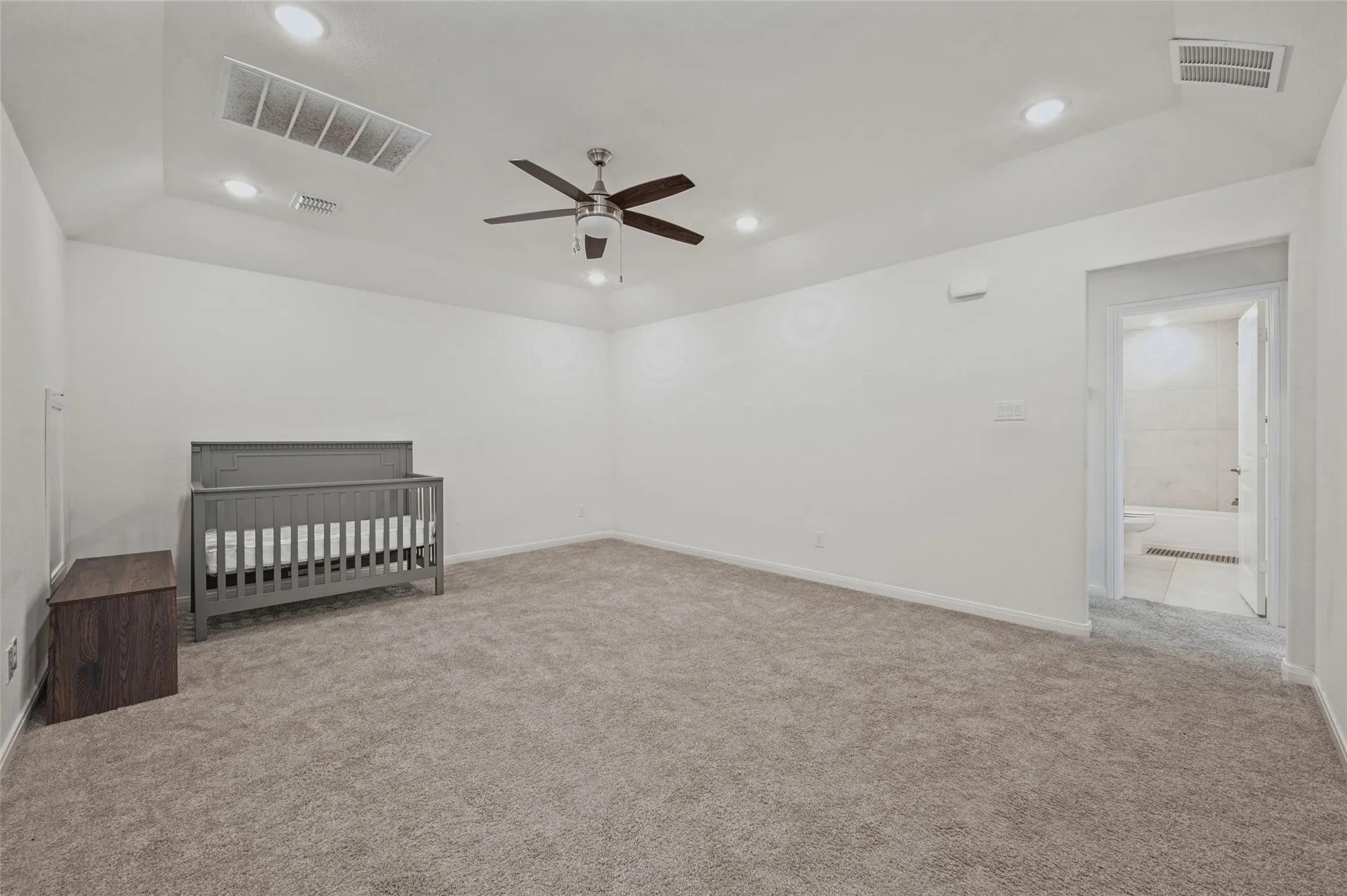 Recessed lighting, ceiling fan, and plush carpet flooring