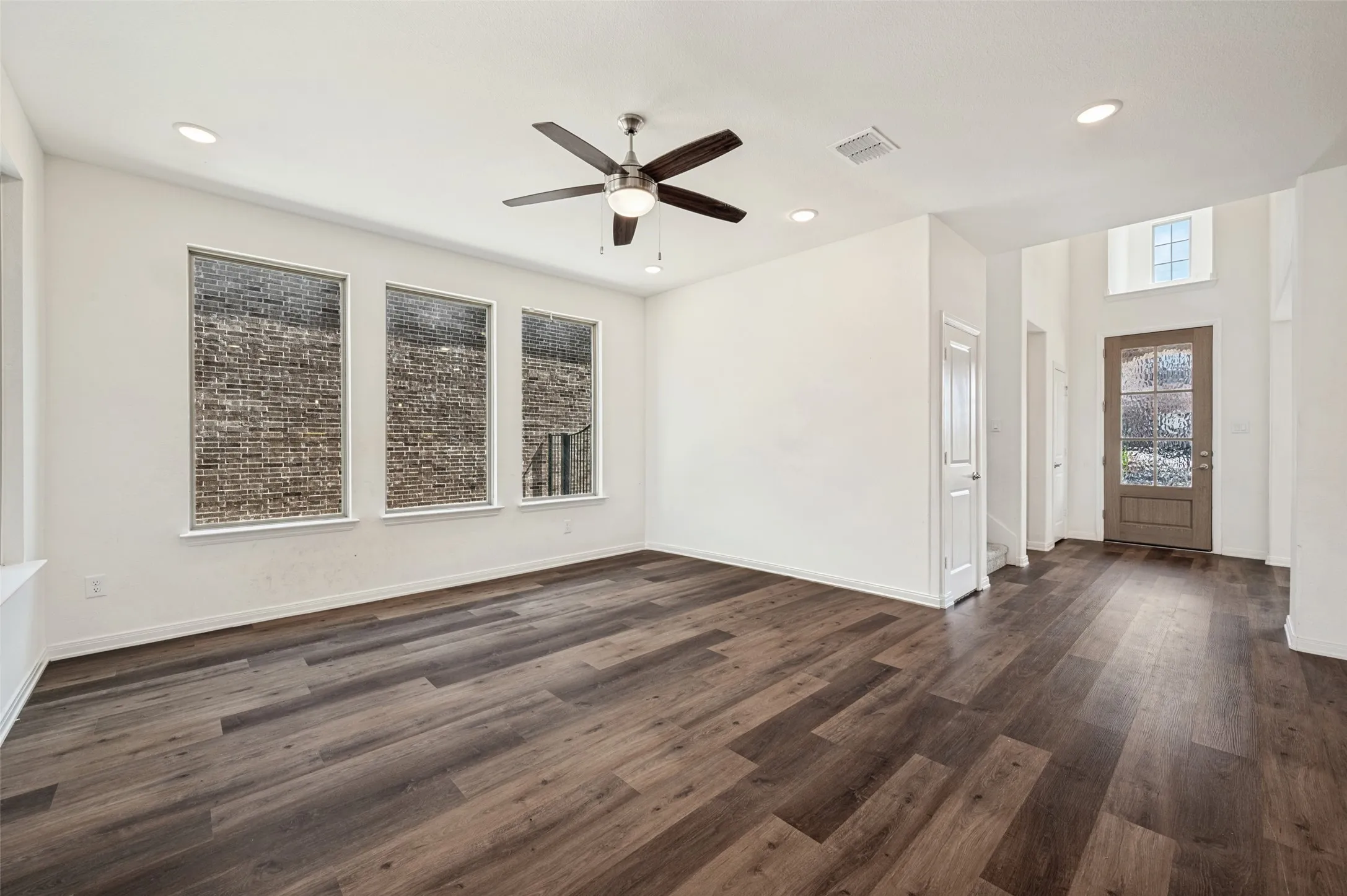 Expansive interior with wood-finish flooring, recessed lighting, and a ceiling fan