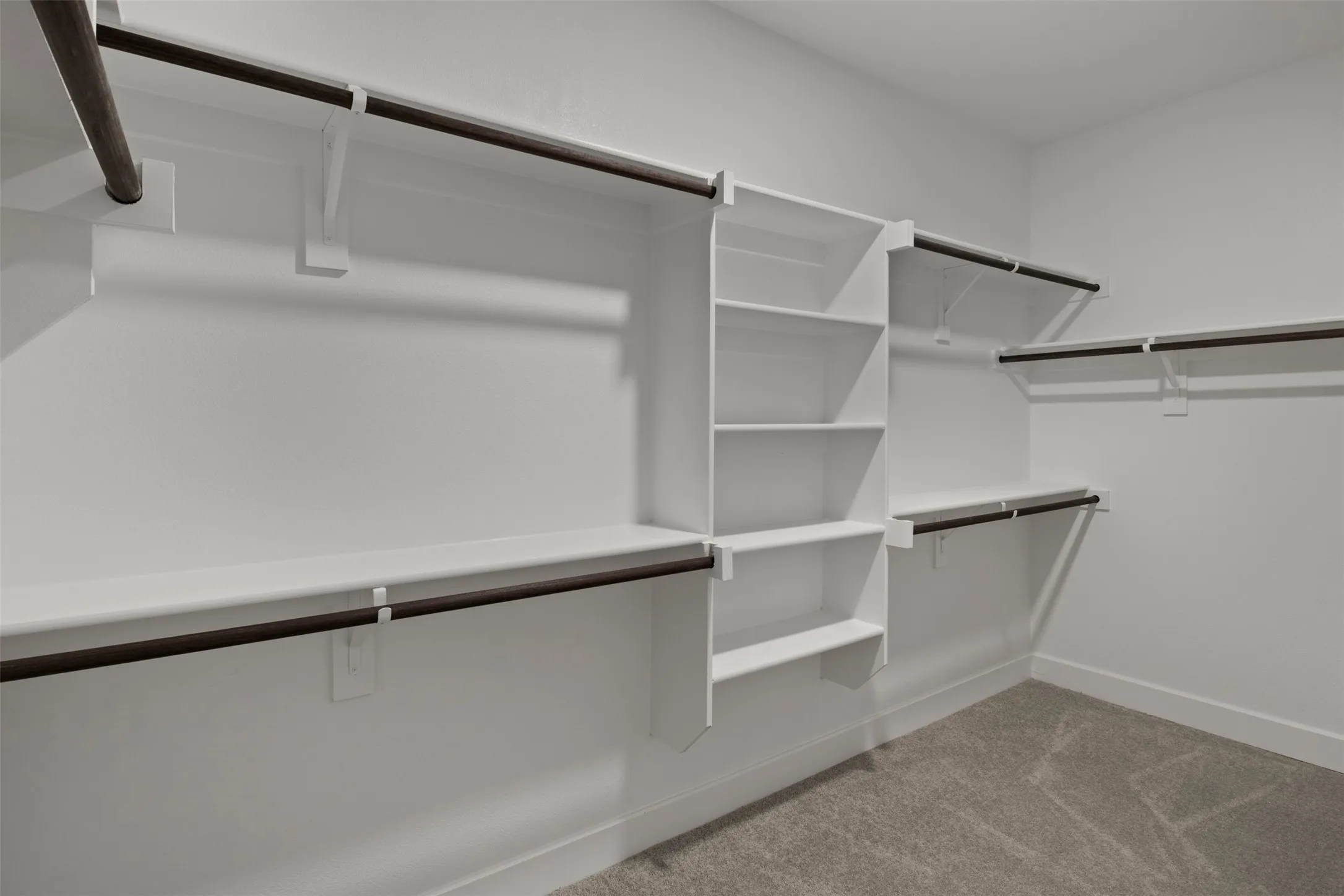 Custom closet system featuring multiple shelves and hanging rods