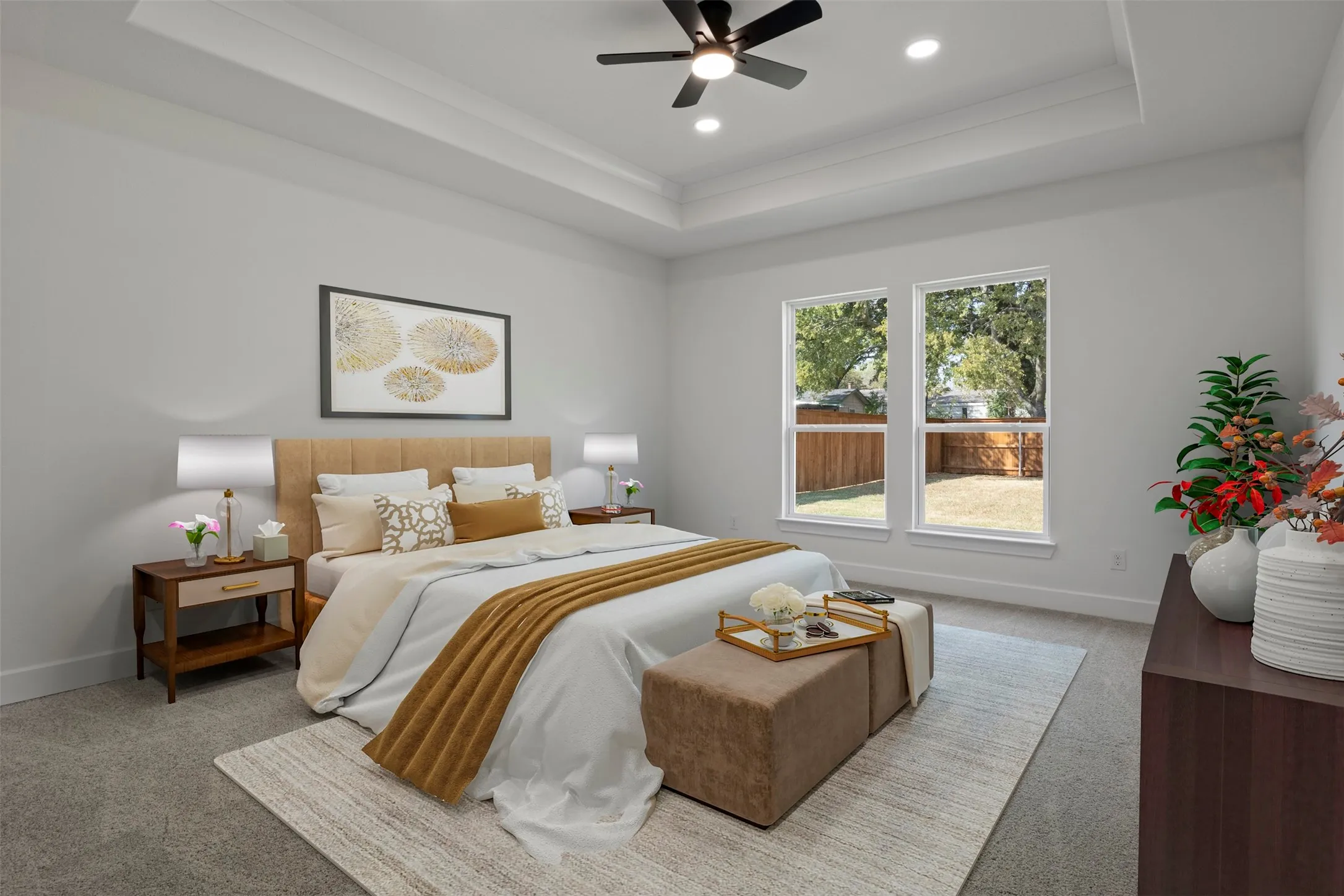 Tray ceiling with recessed lighting and a ceiling fan, two large windows, and wall-to-wall carpeting