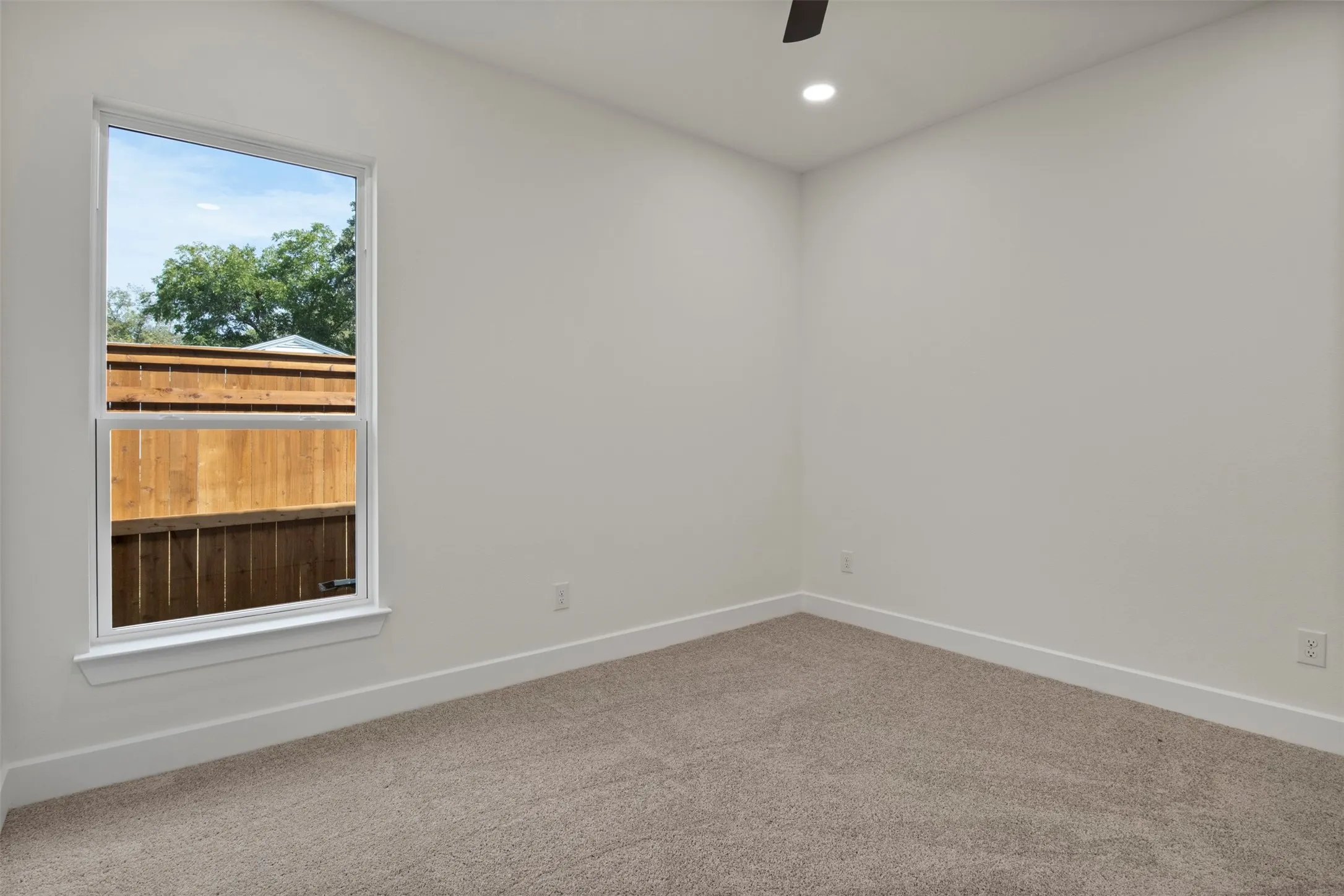 Recessed lighting, ceiling fan, white walls, and carpet flooring