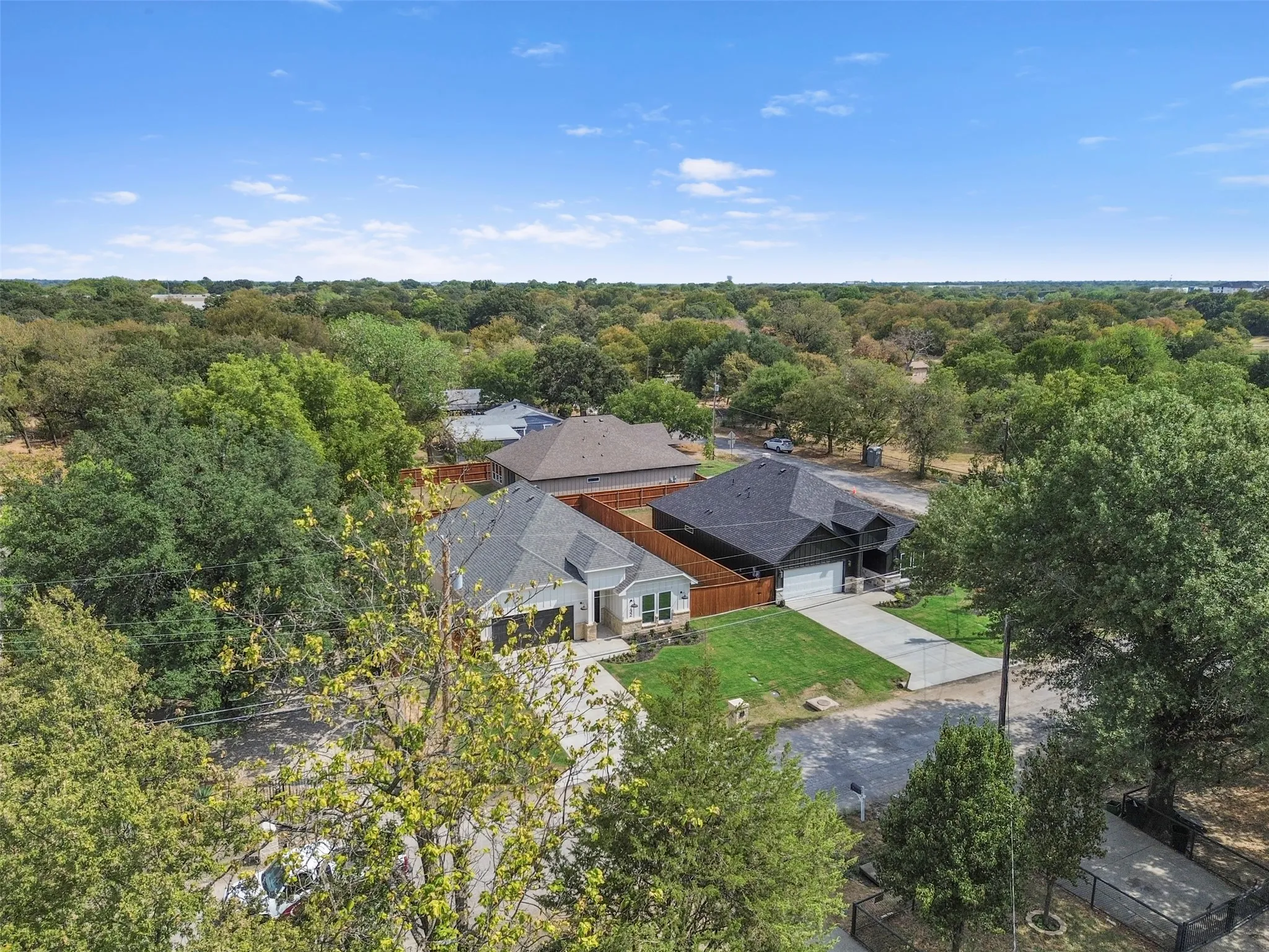 Aerial perspective showcasing residential properties with a rich tree canopy