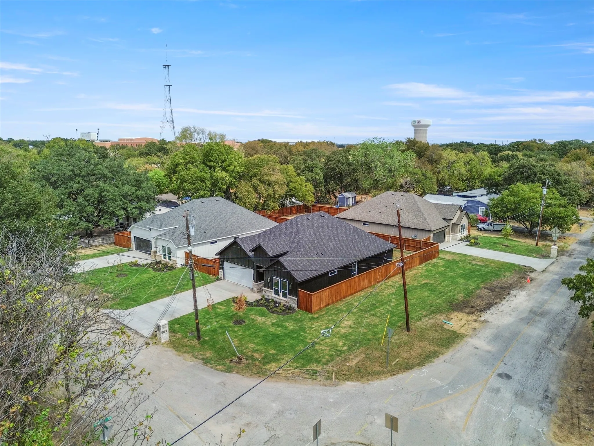Pitched roofline on a single-story structure, with an attached garage and privacy fencing