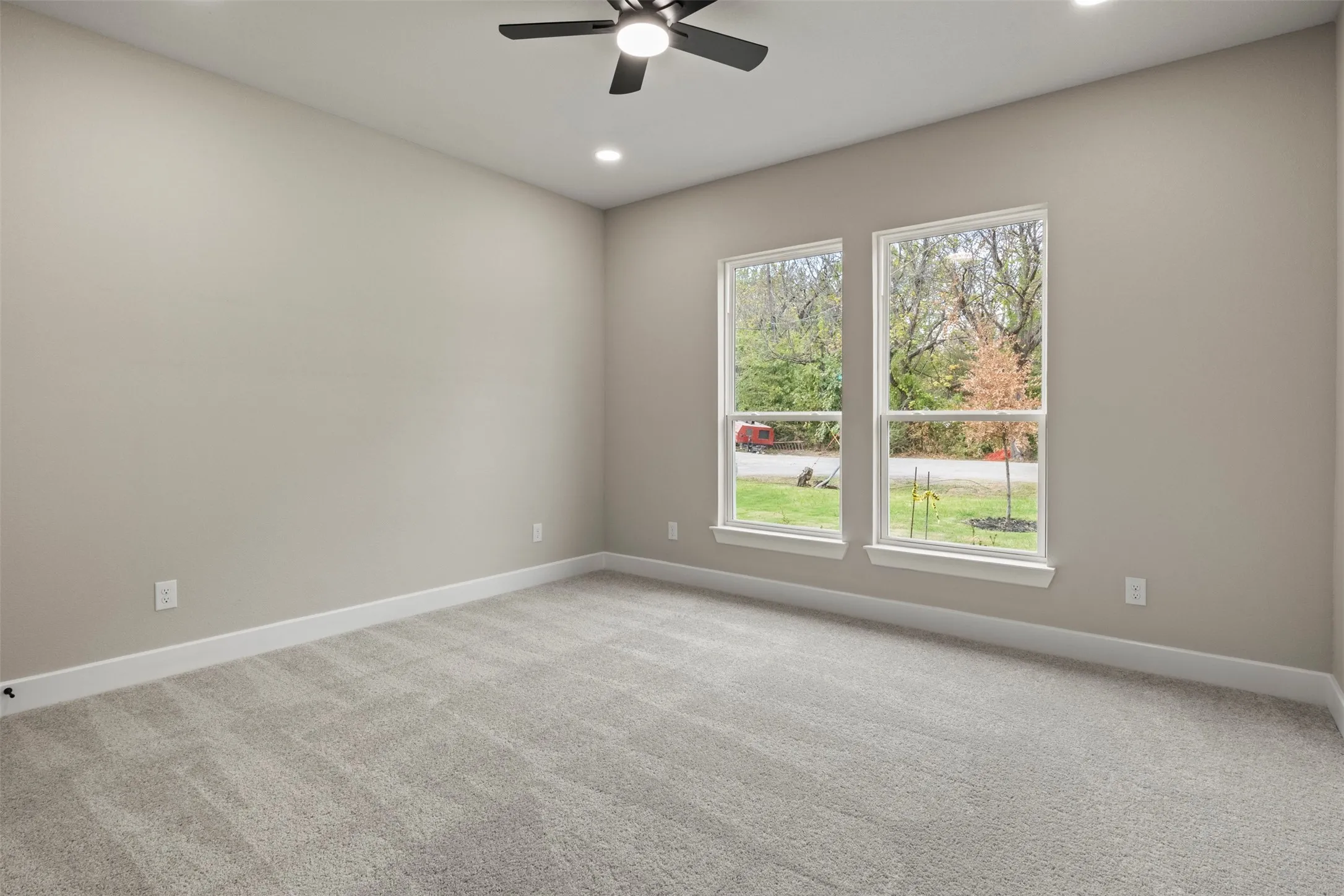 Neutral wall color, recessed lighting, ceiling fan, carpeting, and double-paned windows