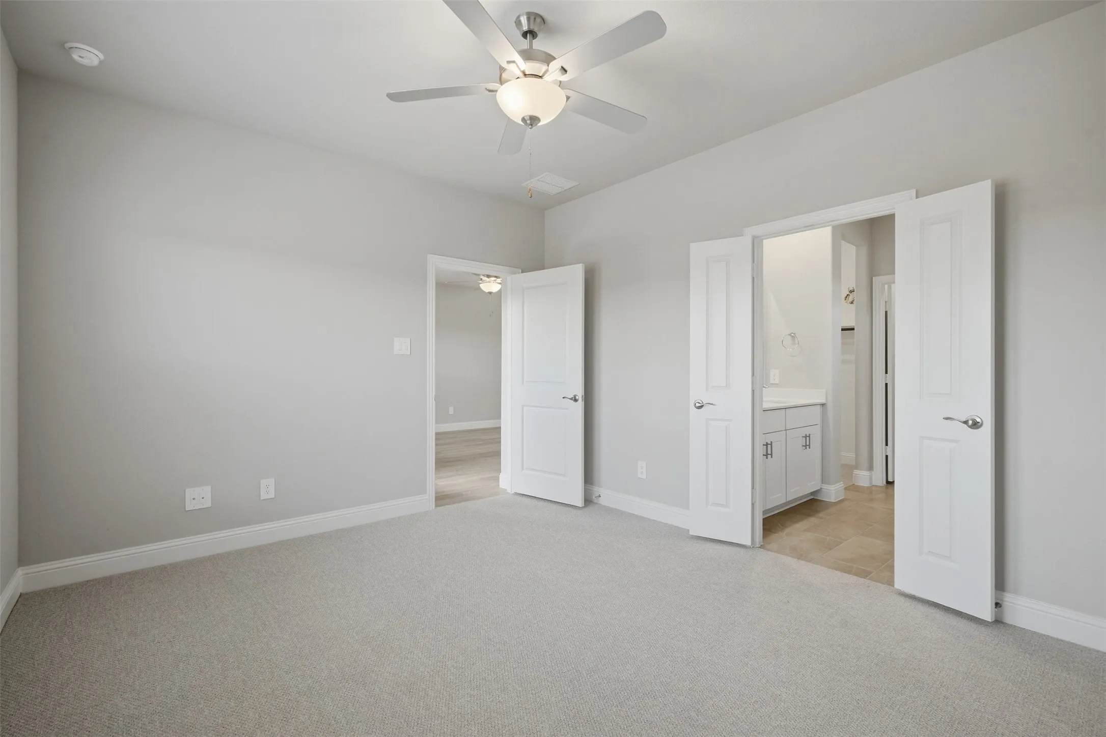 Plush carpet flooring, ceiling fan with integrated lighting, recessed lighting, and multiple panel doors