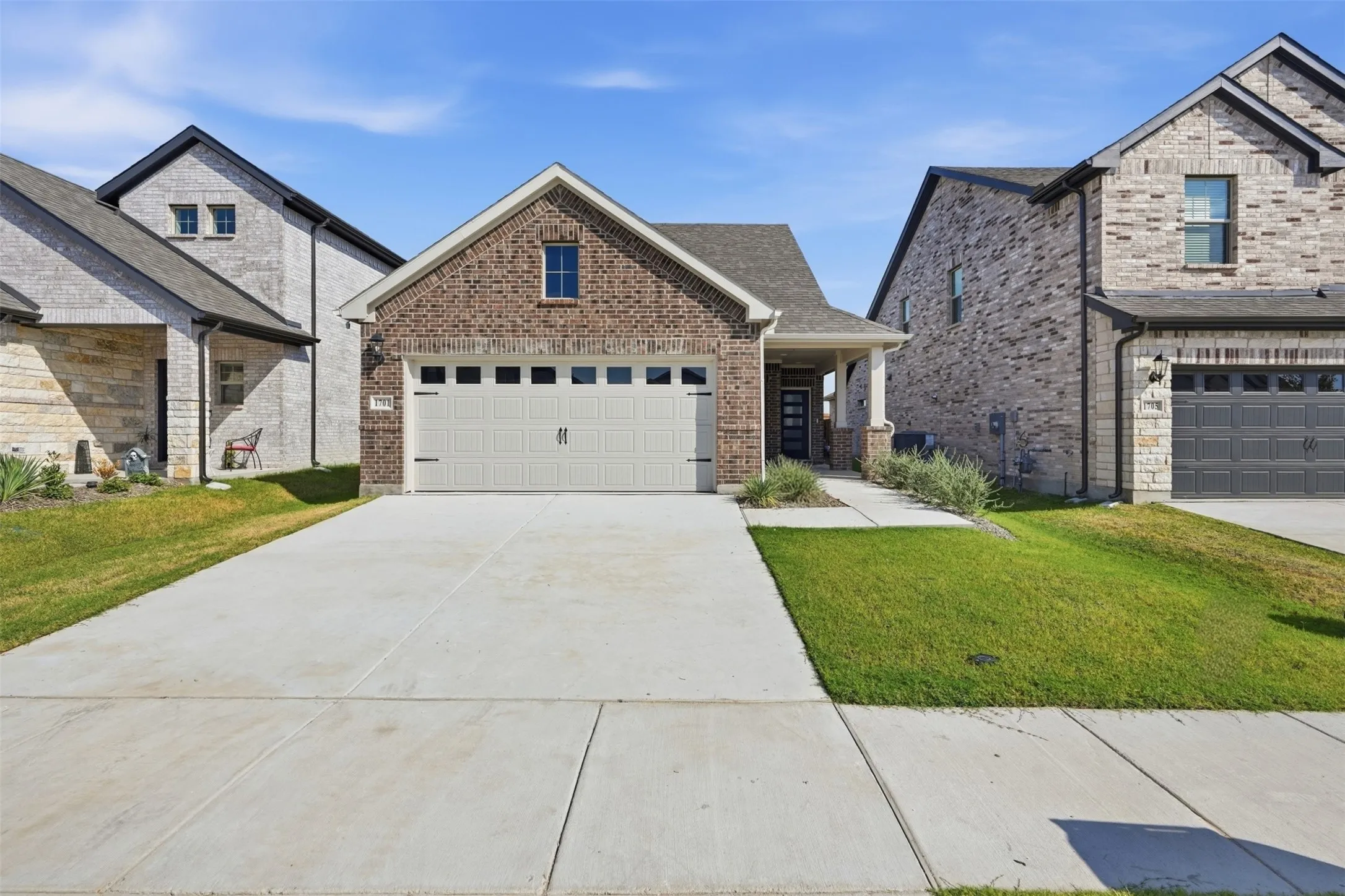 Brick exterior with a gabled roof and a two-car garage