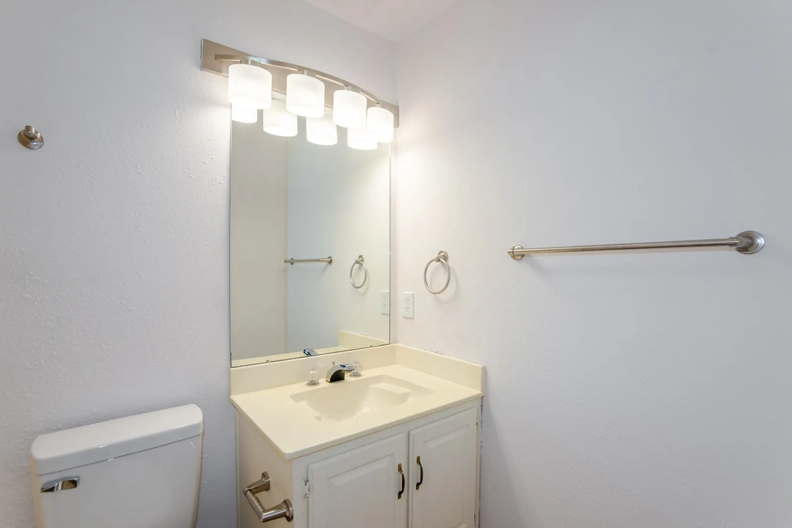White vanity with an integrated sink and chrome faucet