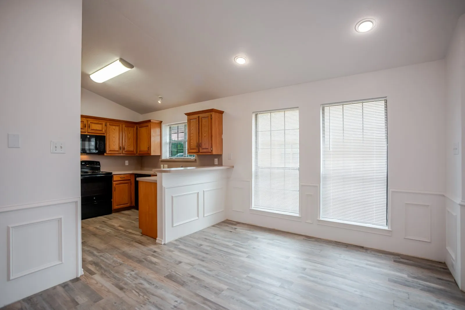 Light wood-finish flooring with white wainscoting