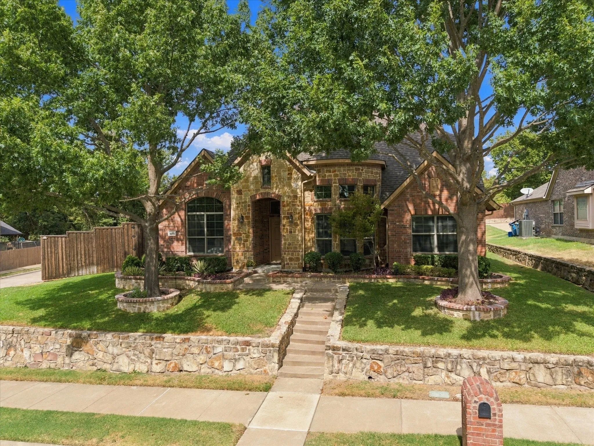 Mature trees add to this home's beautiful curb appeal!