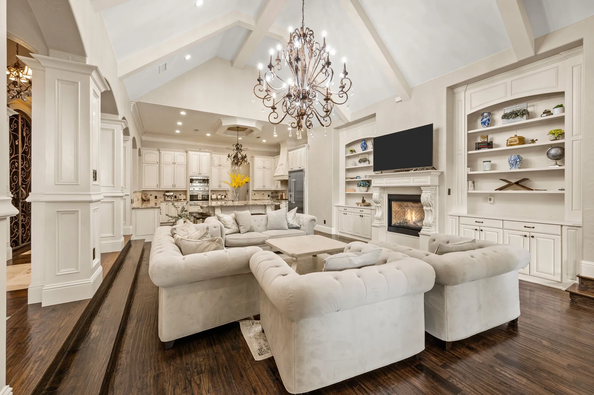 Vaulted ceiling with exposed beams and central chandelier