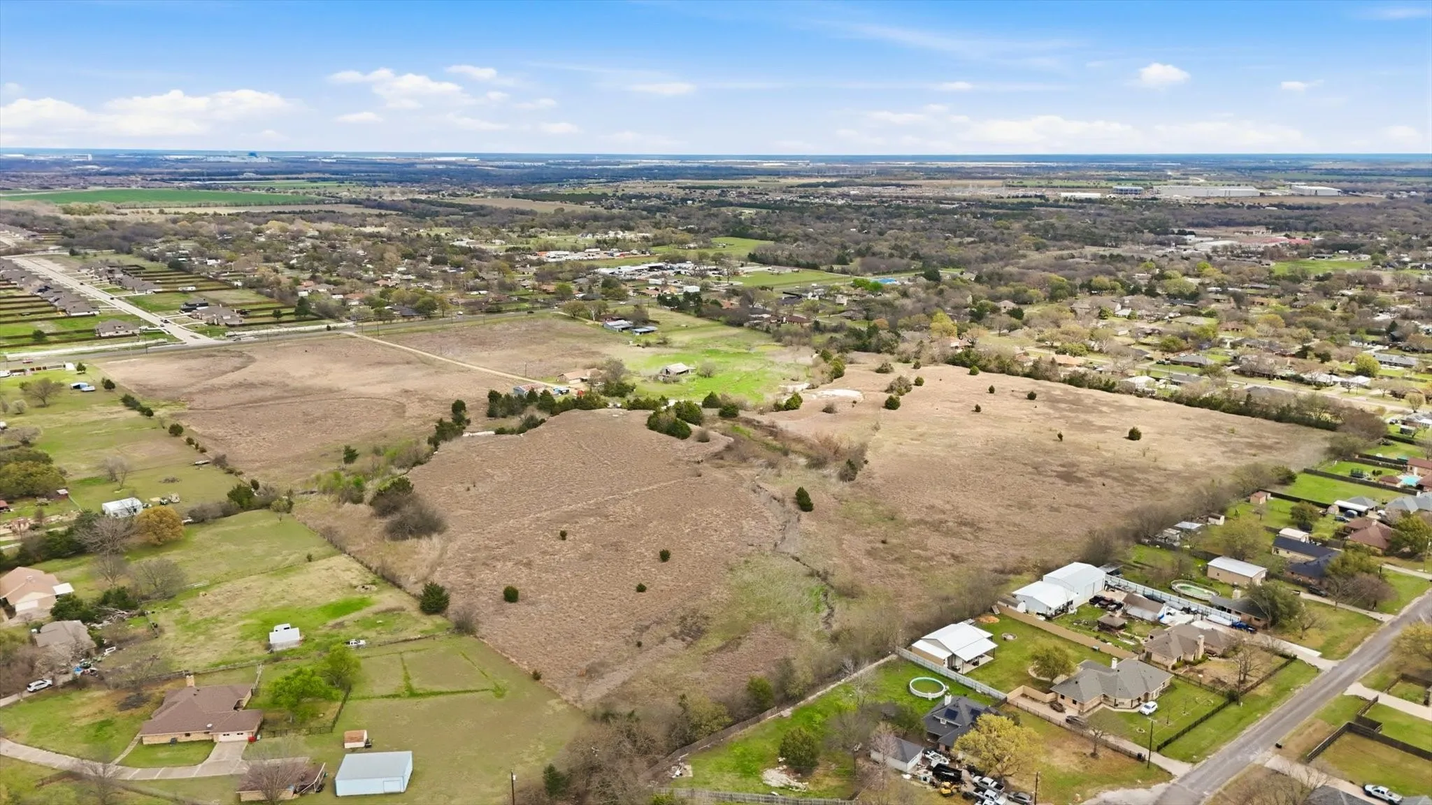View of rural area featuring nearby suburban area
