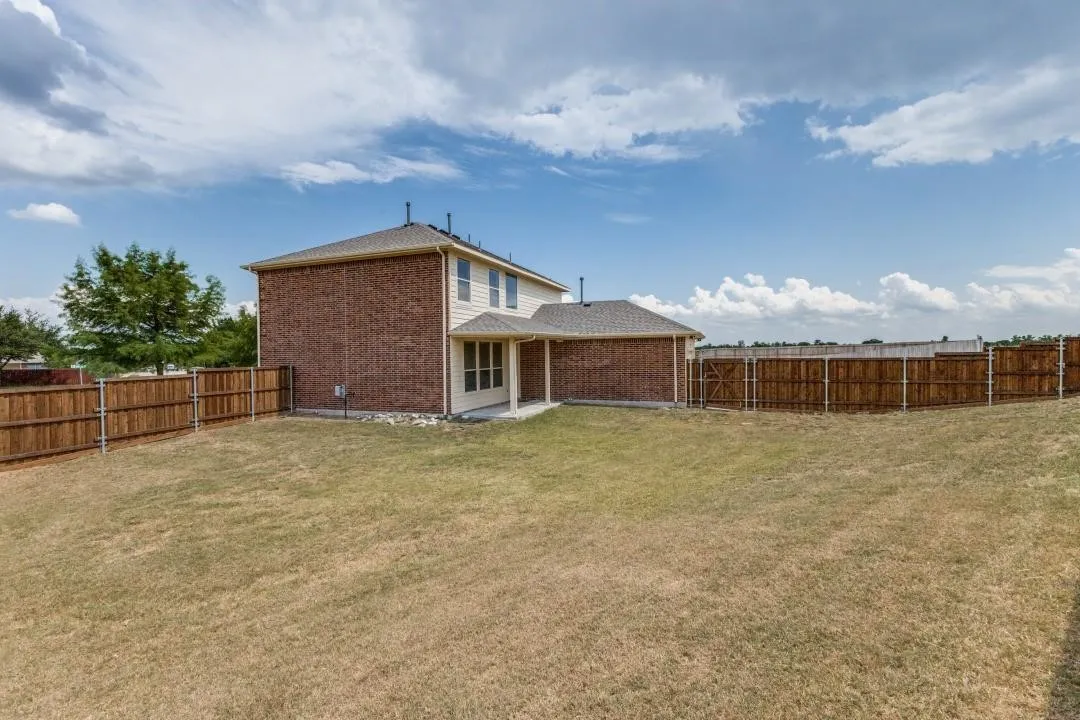 Expansive lawn area with a full privacy fence