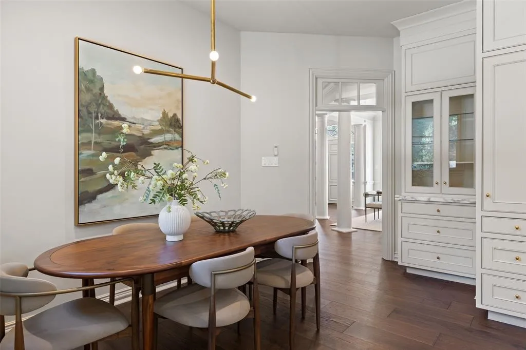 Built-in cabinetry with glass-front display, dark wood-finish flooring, recessed lighting, and a modern linear chandelier