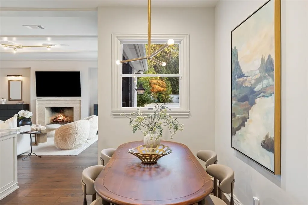 Hardwood flooring, a natural light window, and a built-in fireplace