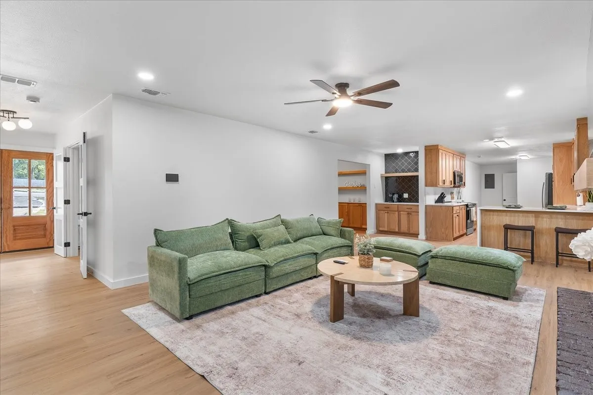 Open concept living area featuring wood-finish flooring, recessed lighting, and a ceiling fan