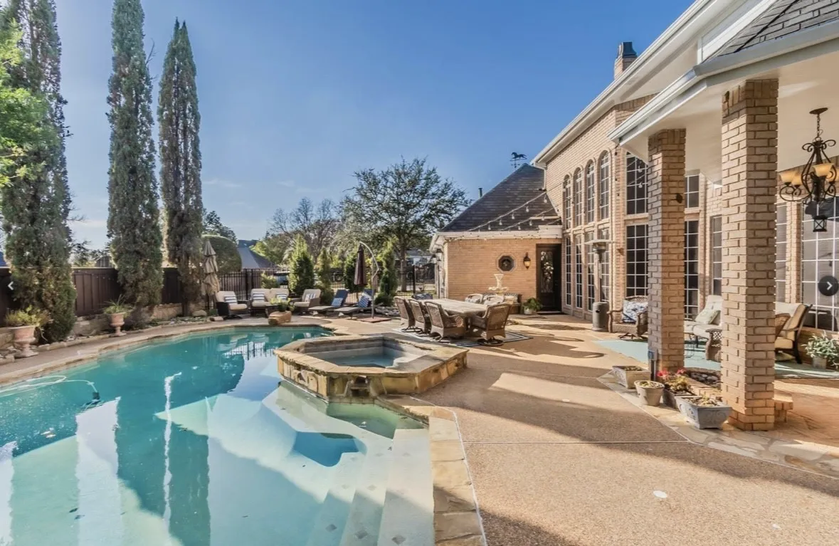 View of pool with an in ground hot tub and a patio