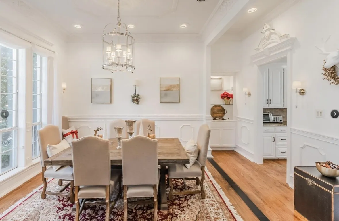 Dining area with a chandelier, crown molding, and light hardwood / wood-style flooring
