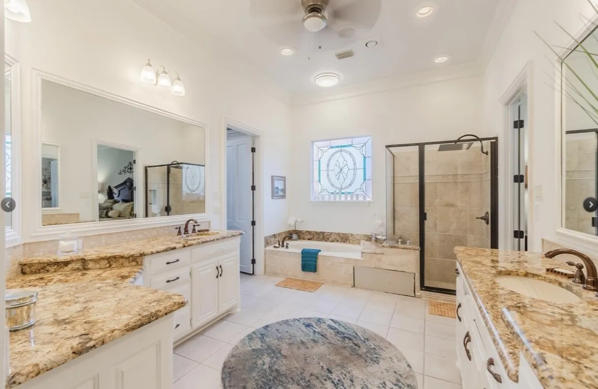 Bathroom with crown molding, vanity, ceiling fan, and shower with separate bathtub