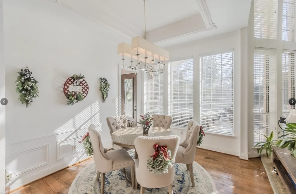 Dining space featuring wood-type flooring, an inviting chandelier, and crown molding