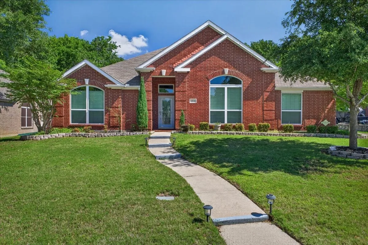 Red brick facade featuring arched and rectangular windows