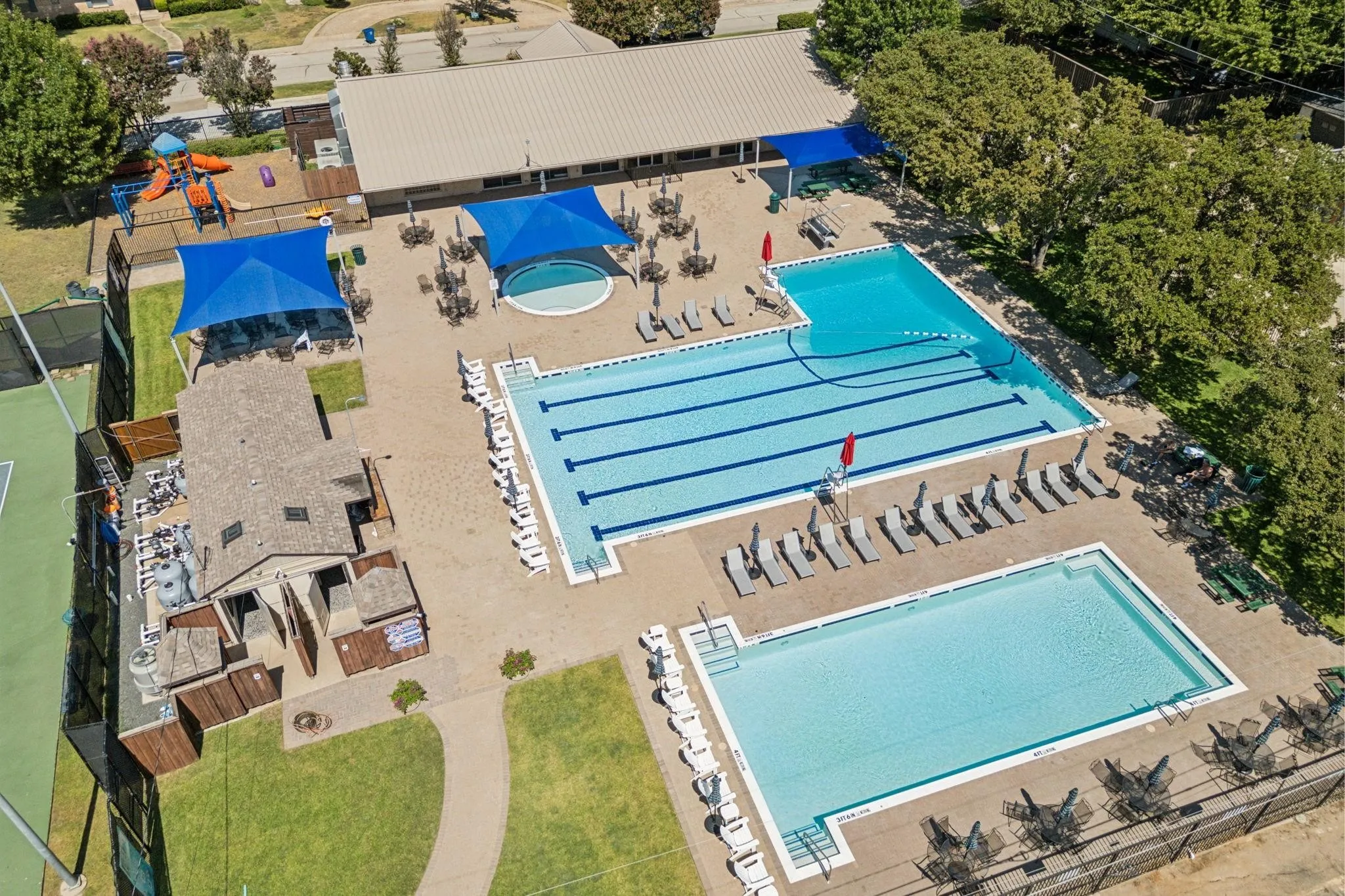 Multiple swimming pools with integrated spa, tennis courts, and a playground