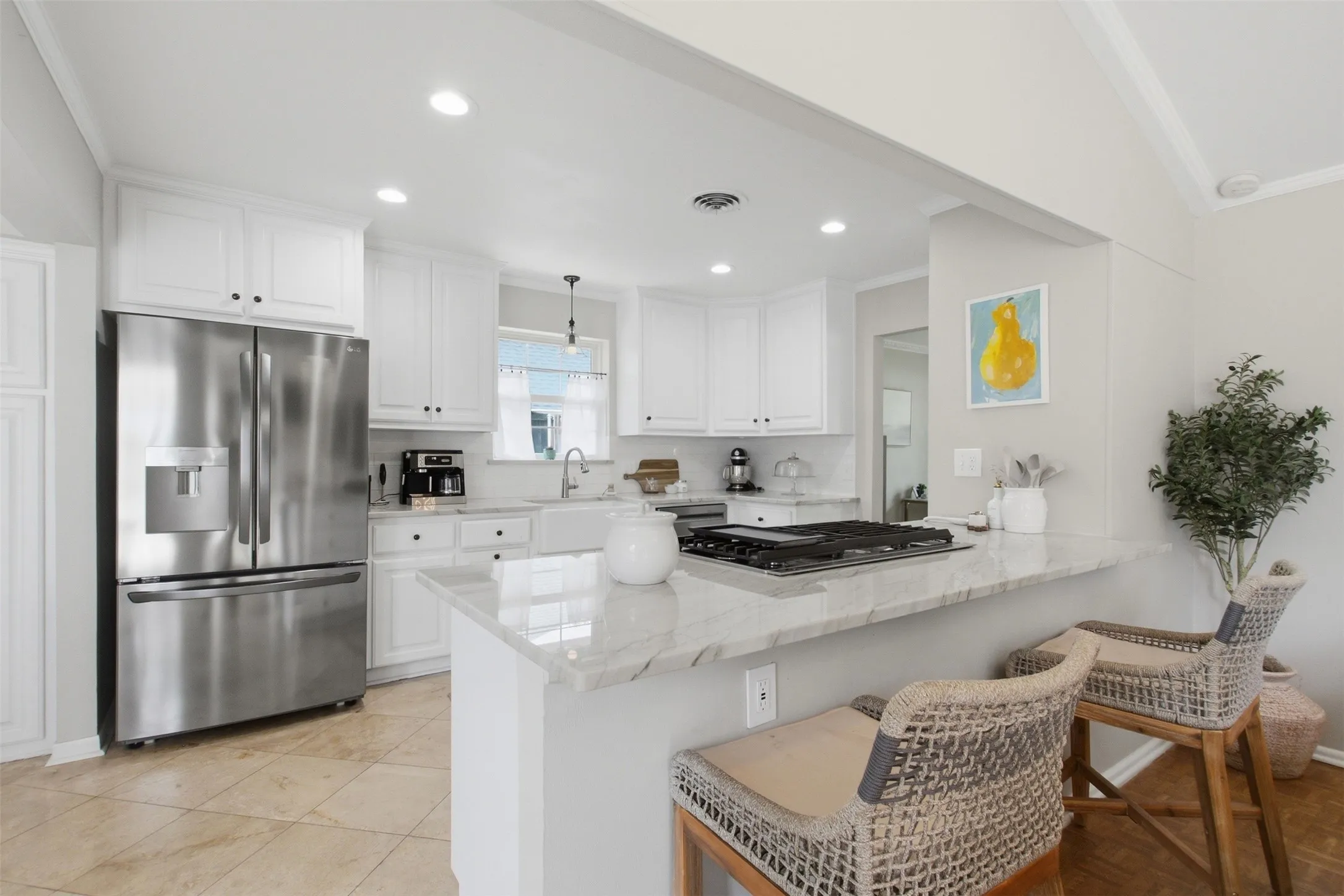 Kitchen featuring white cabinetry, stainless steel appliances, a built-in gas cooktop, stone countertops, and tile flooring