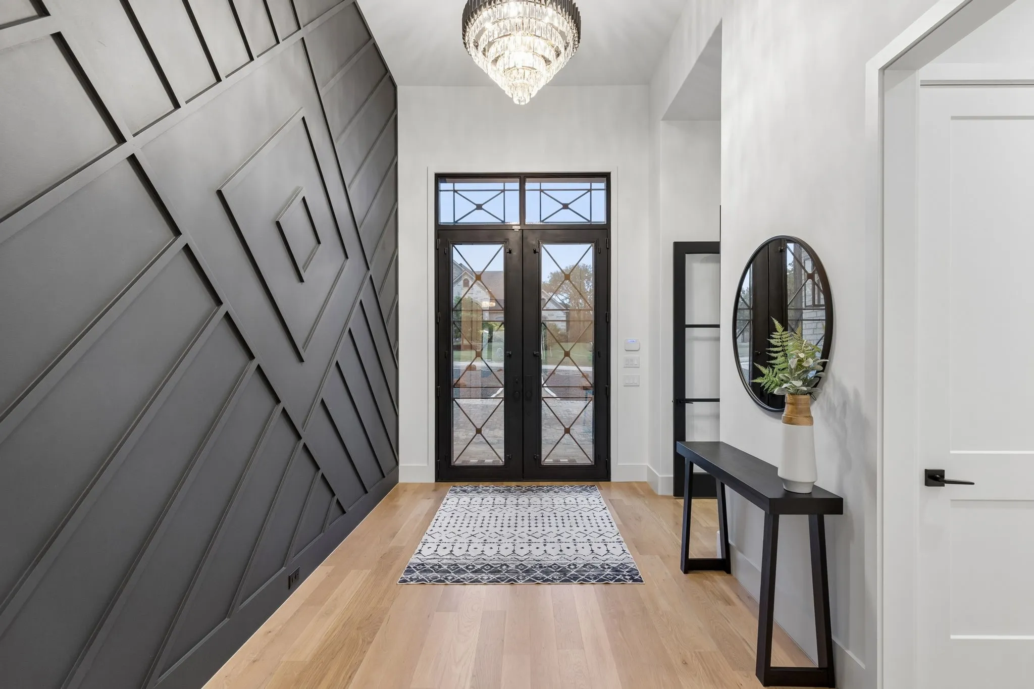 Custom accent wall with designer lighting in foyer.