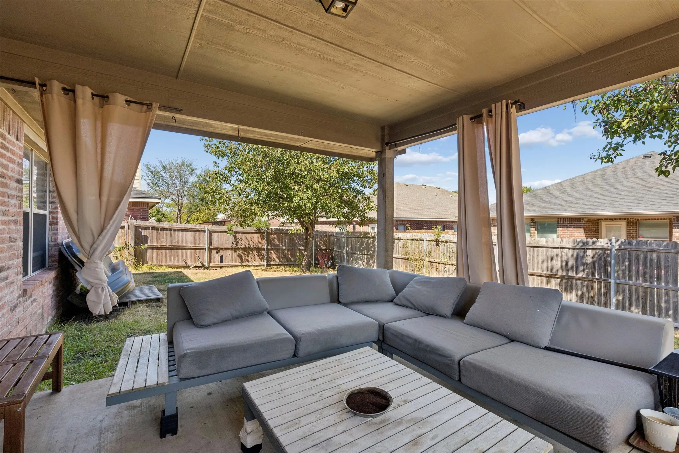 Covered patio featuring a concrete slab and wood-finish ceiling
