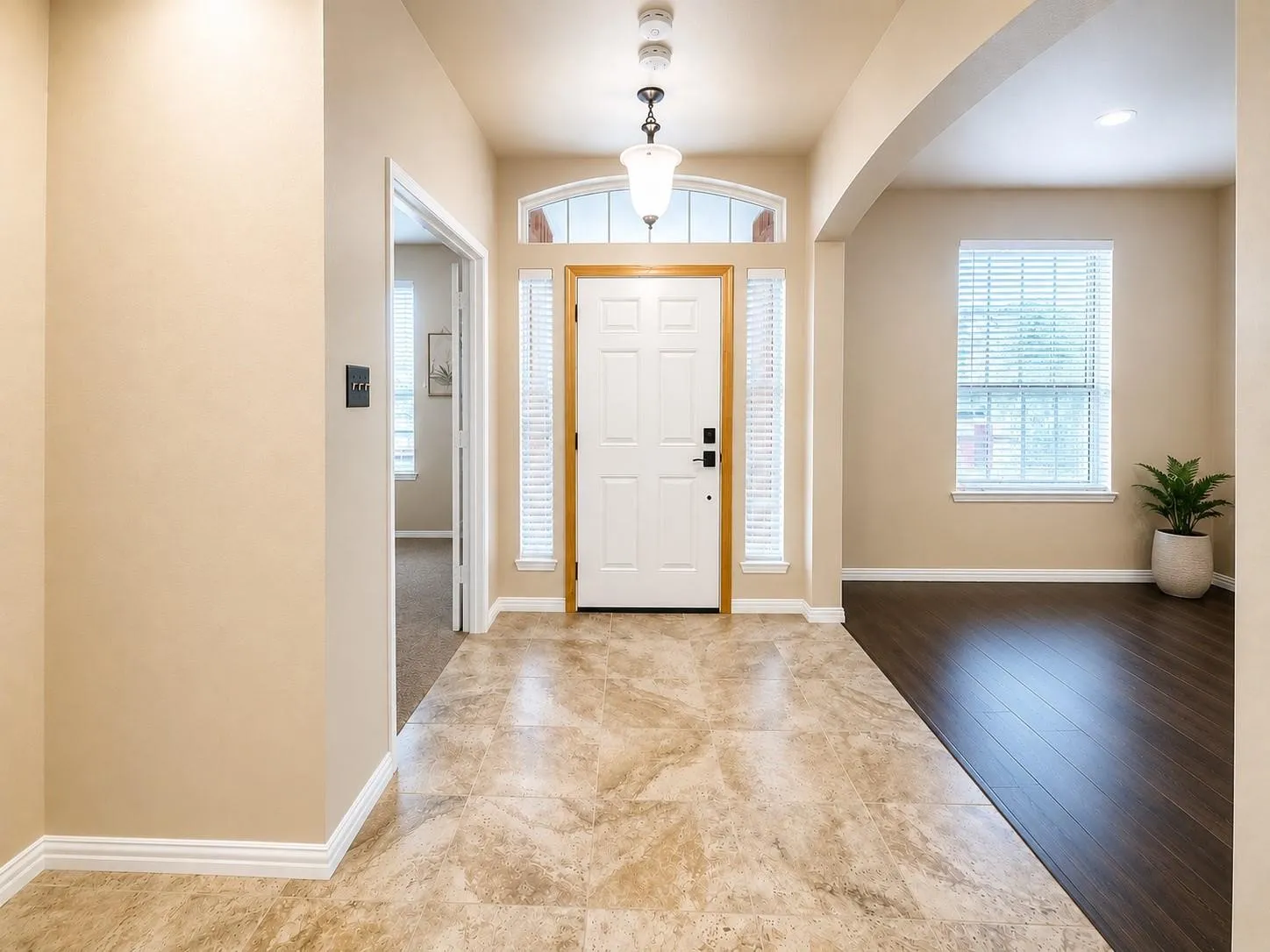 Foyer featuring tile flooring, a white front door with sidelights, and a transom window