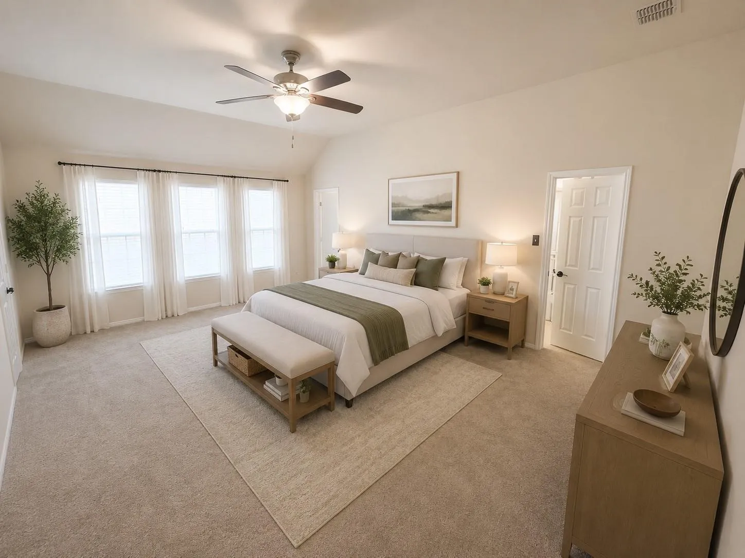 Vaulted ceiling, ceiling fan with integrated lighting, three large windows, neutral carpet flooring, and a paneled door