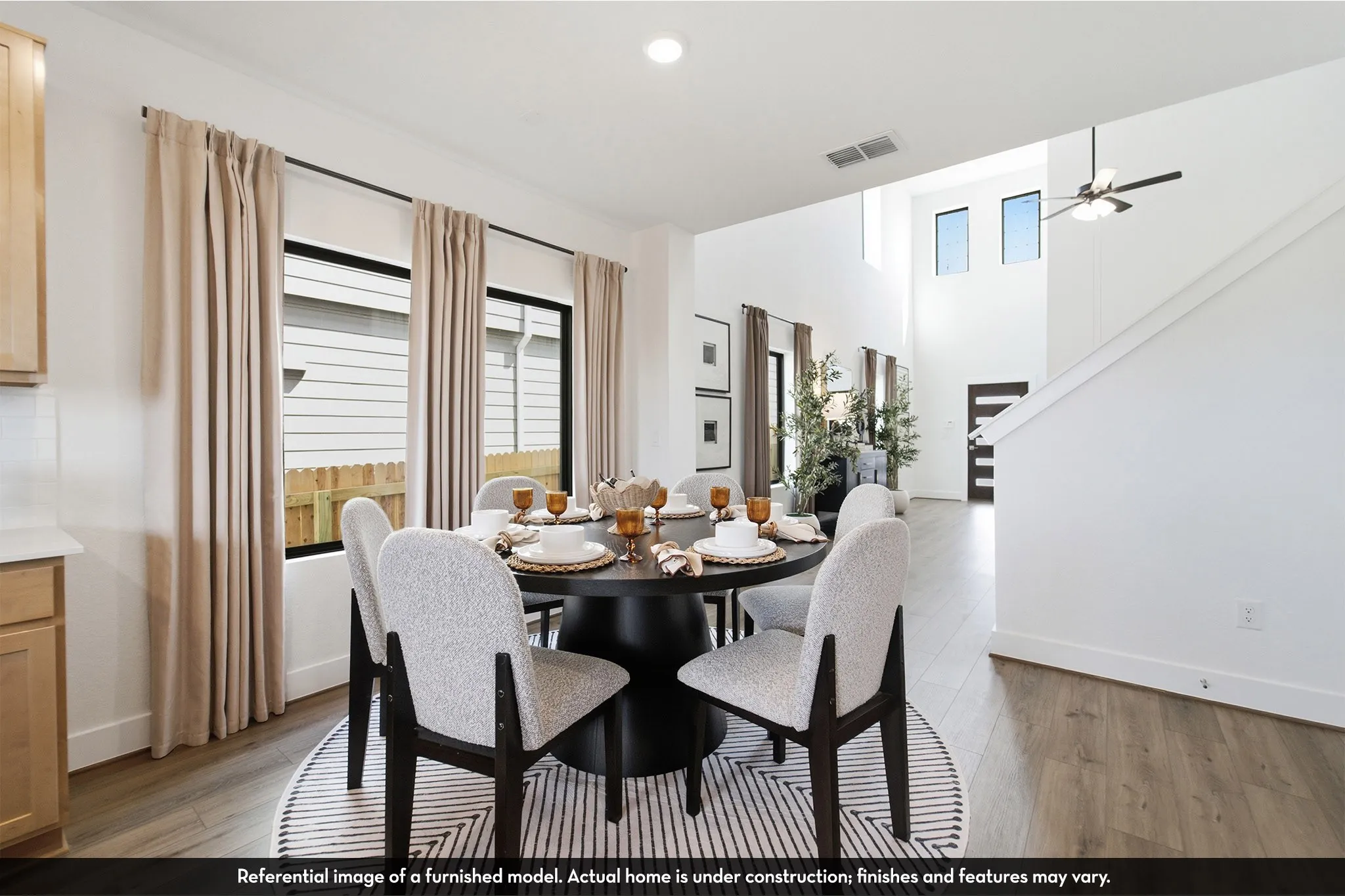 High ceilings, wood-finish flooring, recessed lighting, and a contemporary ceiling fan