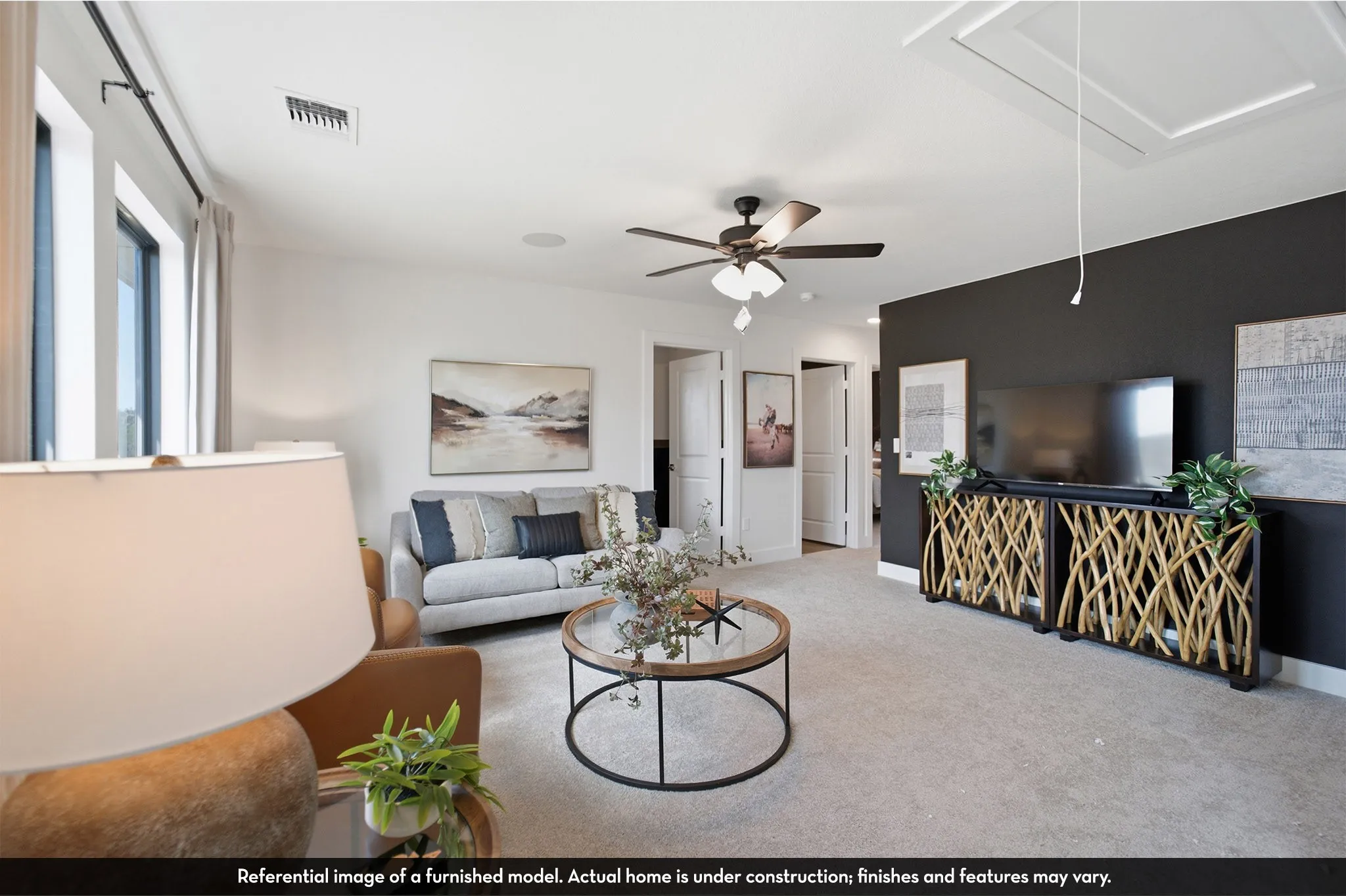 Carpeted living area featuring a ceiling fan, recessed lighting, and a dark accent wall