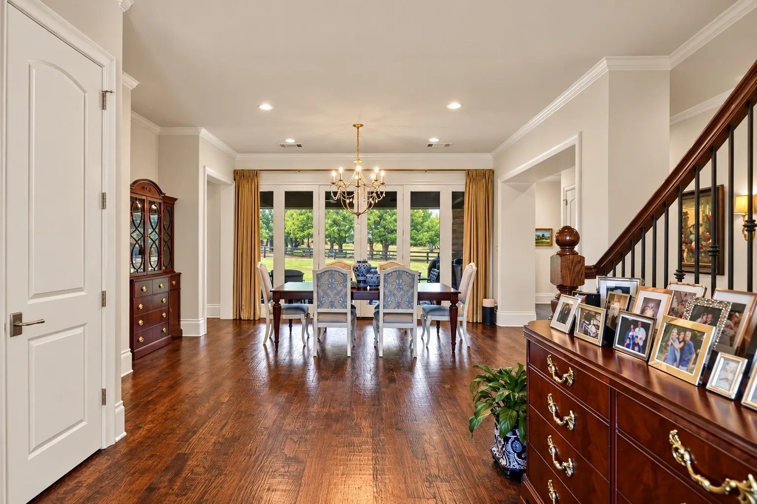 Hardwood flooring throughout, recessed lighting, crown molding, double French doors, and a chandelier