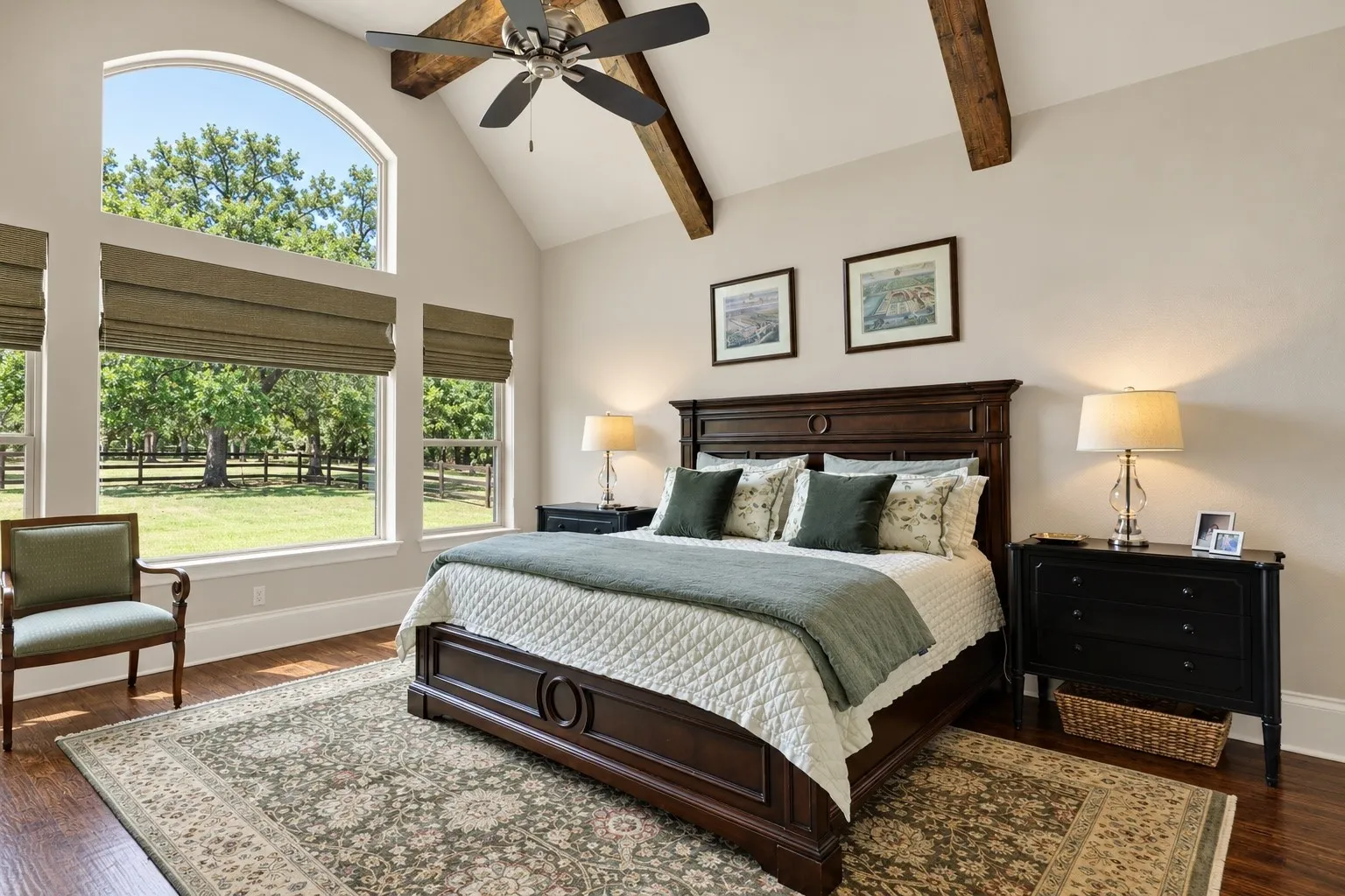 Vaulted ceiling with exposed wood beams, ceiling fan, and arched window