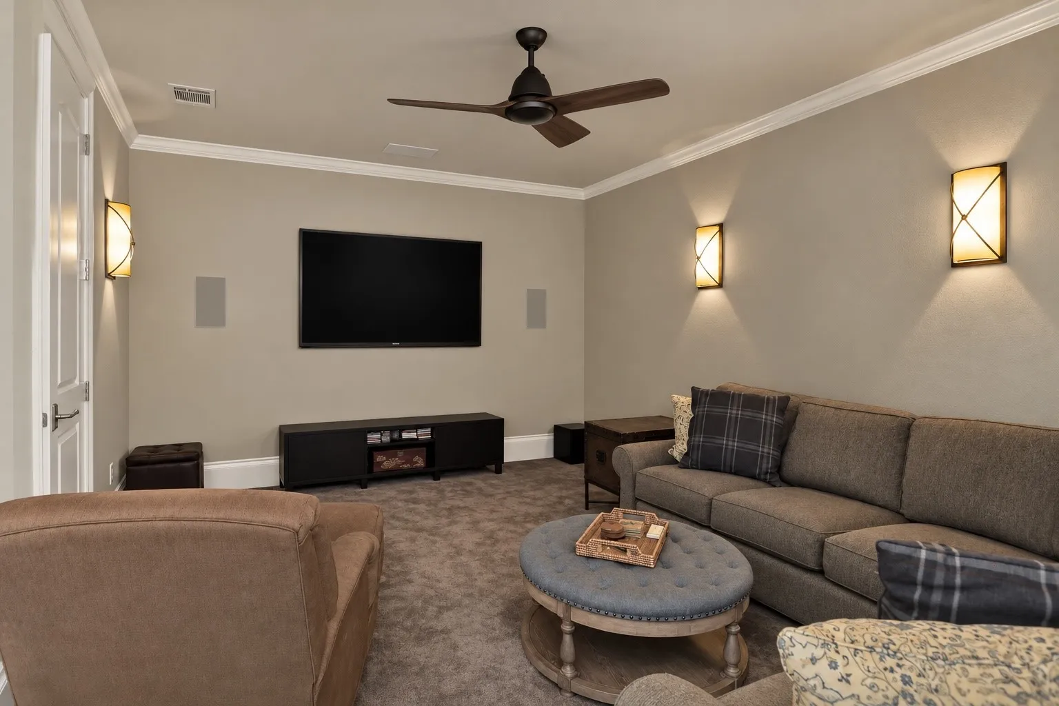 Built-in speakers, recessed lighting, crown molding, wall-mounted television, and ceiling fan