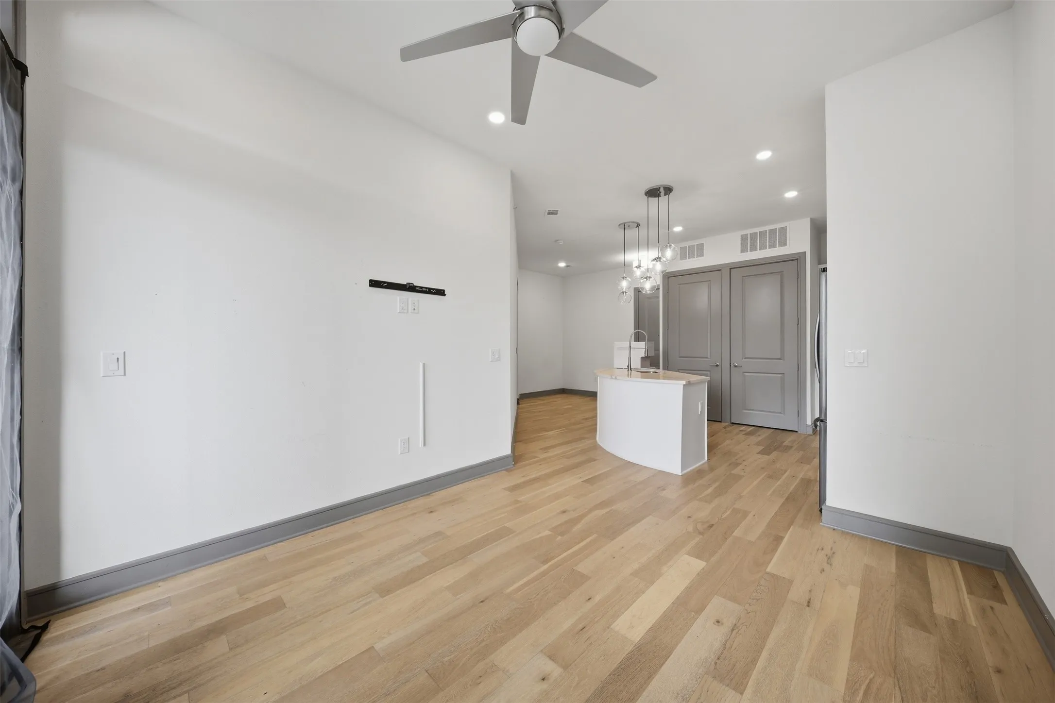 Wood-finish flooring, recessed lighting, and a modern ceiling fan