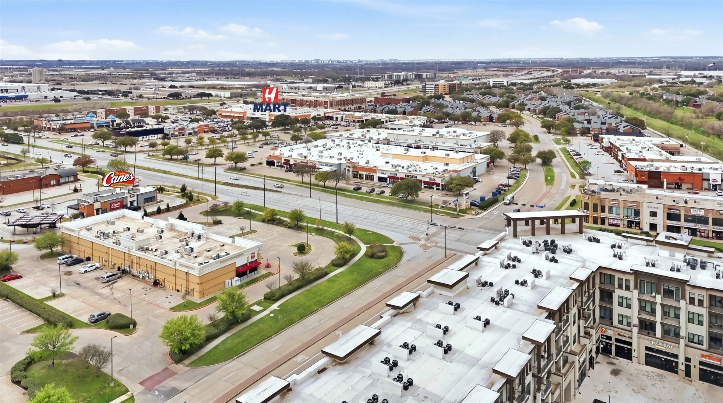 Mixed-use development featuring retail spaces and multi-story residential buildings
