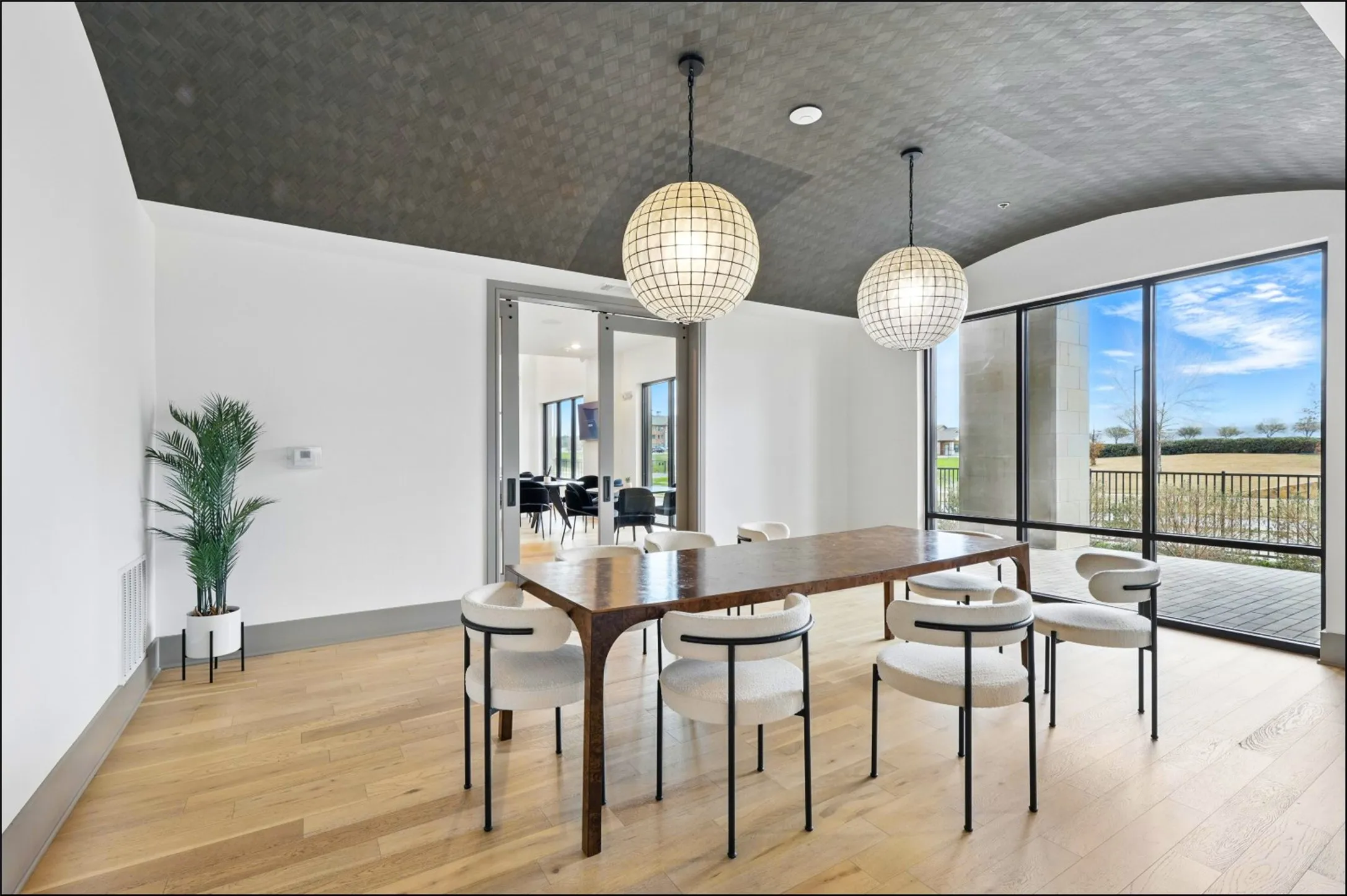 Light wood-finish flooring with a dark patterned ceiling