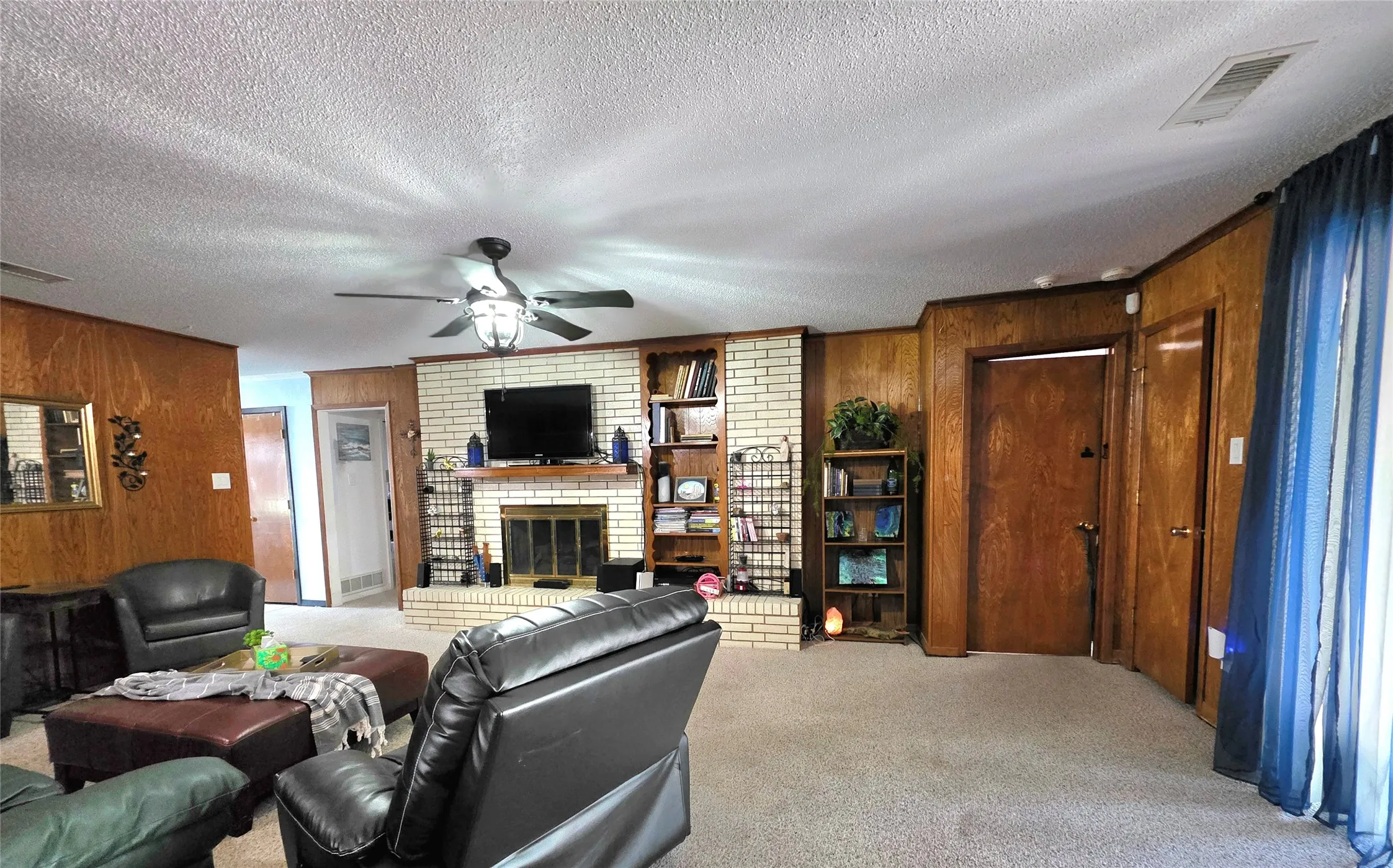 View of the family room featuring the fireplace with hearth.