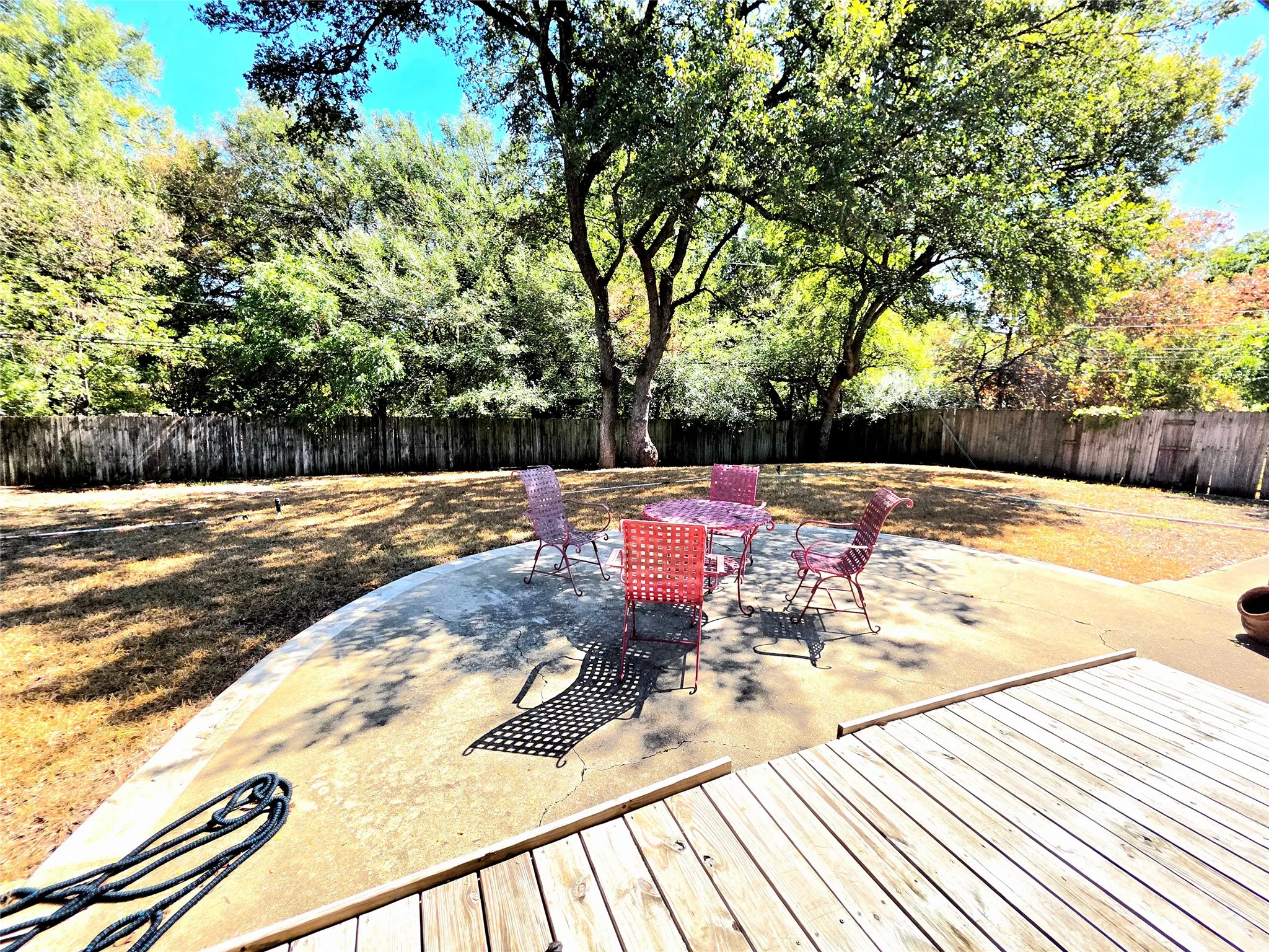 Shaded and inviting patio-View 2 overlooking large, grassy backyard with plenty of room to play.
