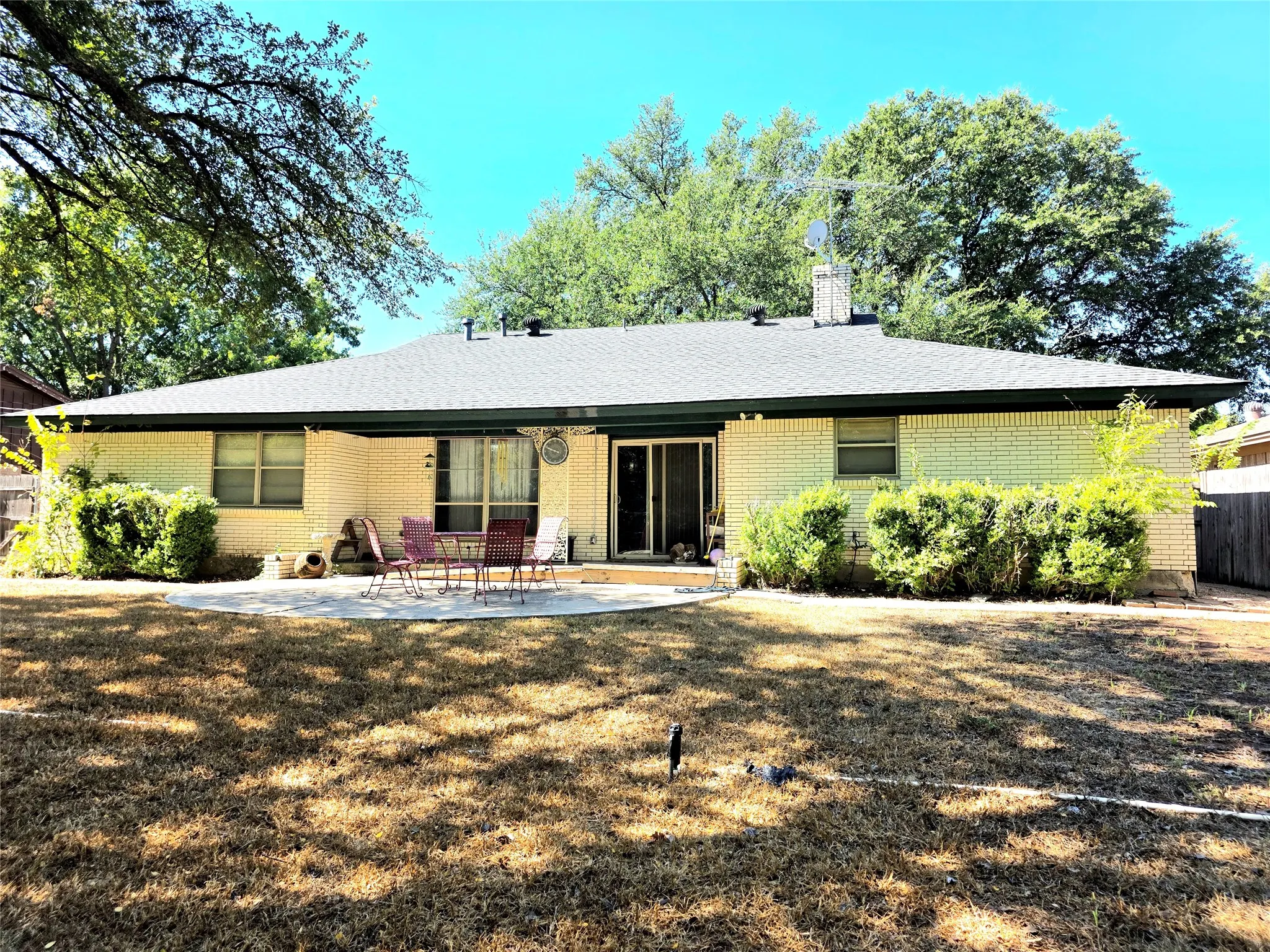 Large Backyard with a covered patio and additional open patio space for entertaining.
