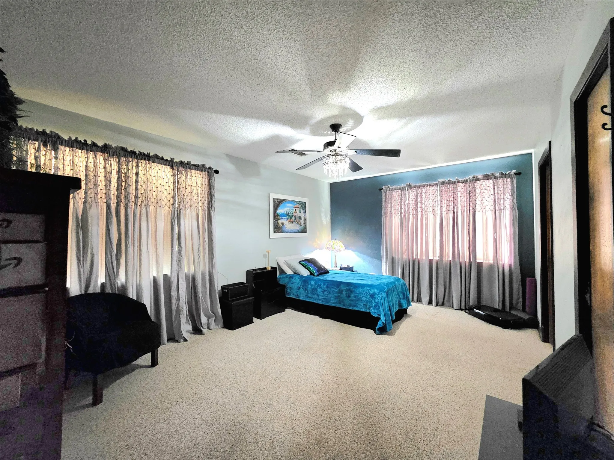 Primary bedroom is very spacious and features a large walk in closet and lots of windows.
