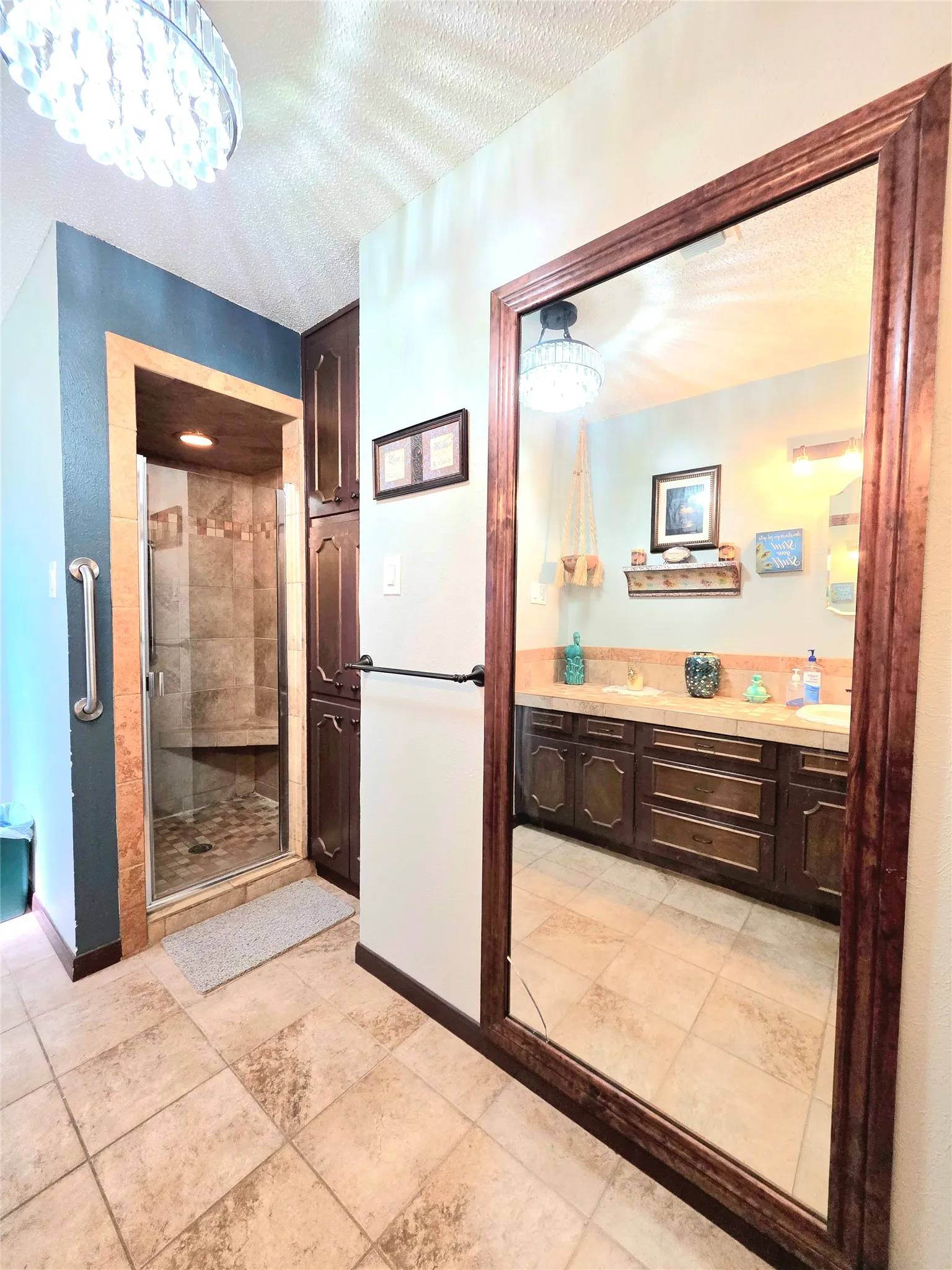 Featuring the Primary Shower with seat and grab bars and the lovely floor to ceiling mirror.
