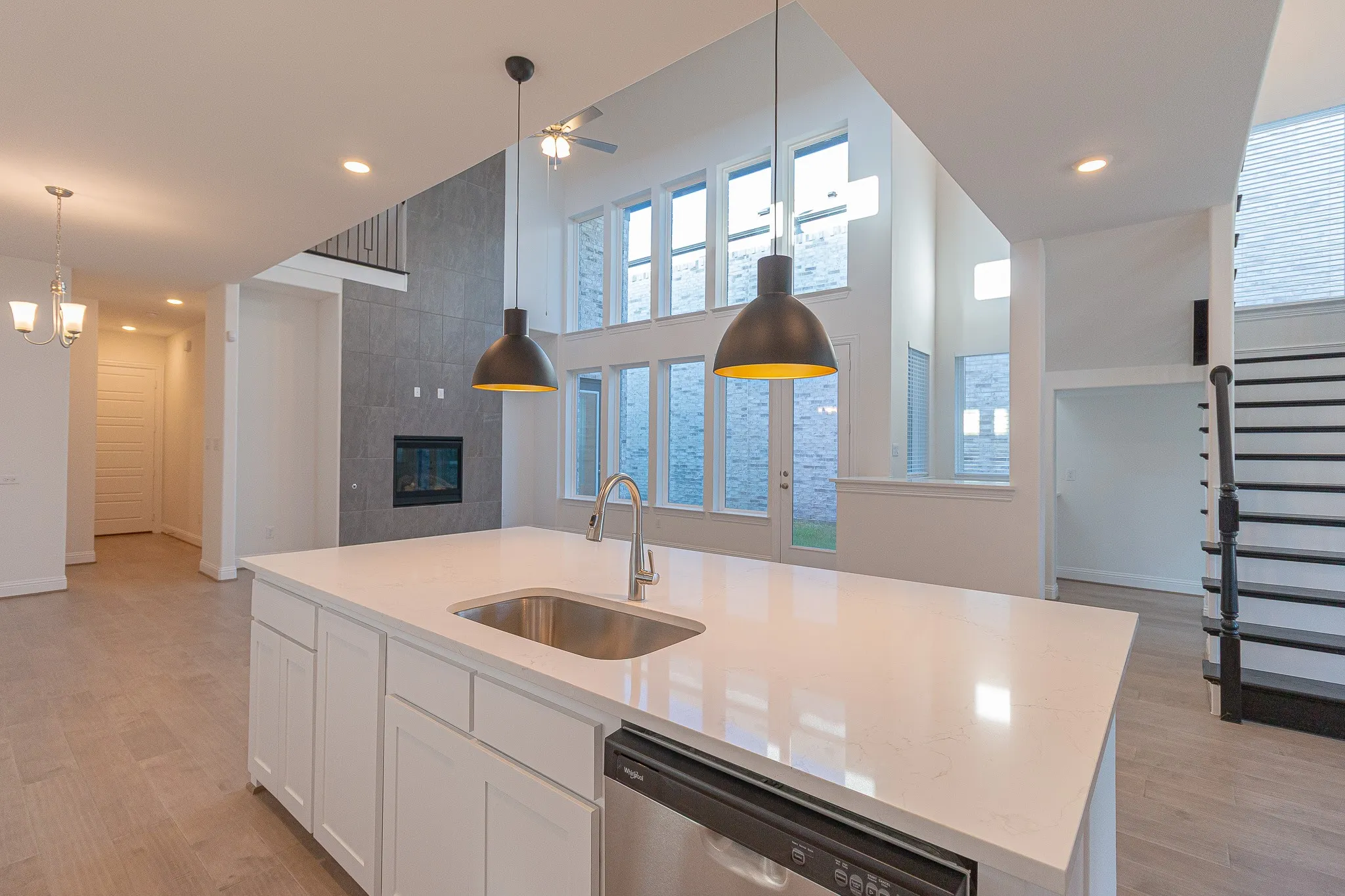 Kitchen featuring dishwasher, pendant lighting, white cabinets, and recessed lighting