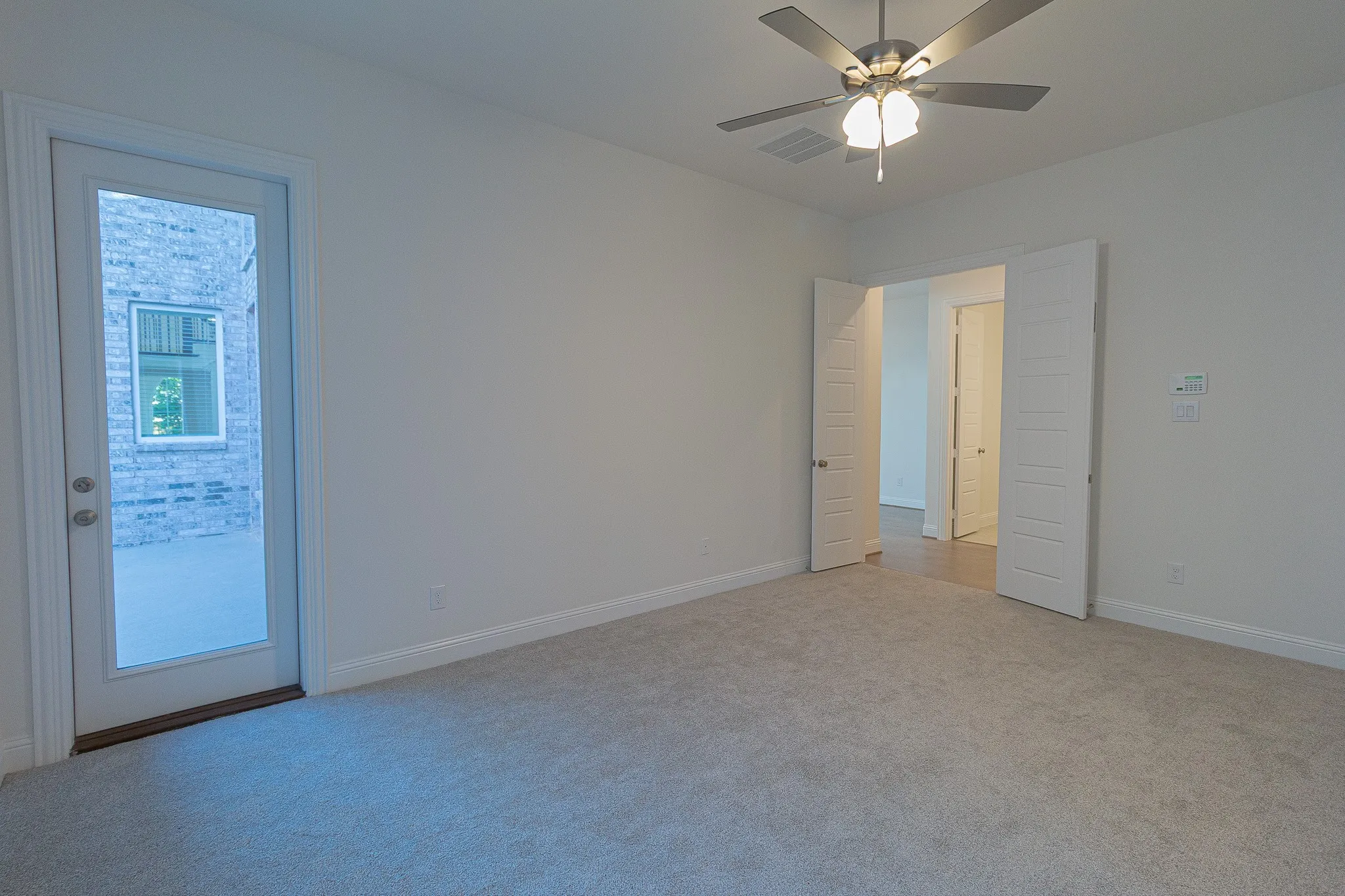Unfurnished room featuring ceiling fan and light colored carpet