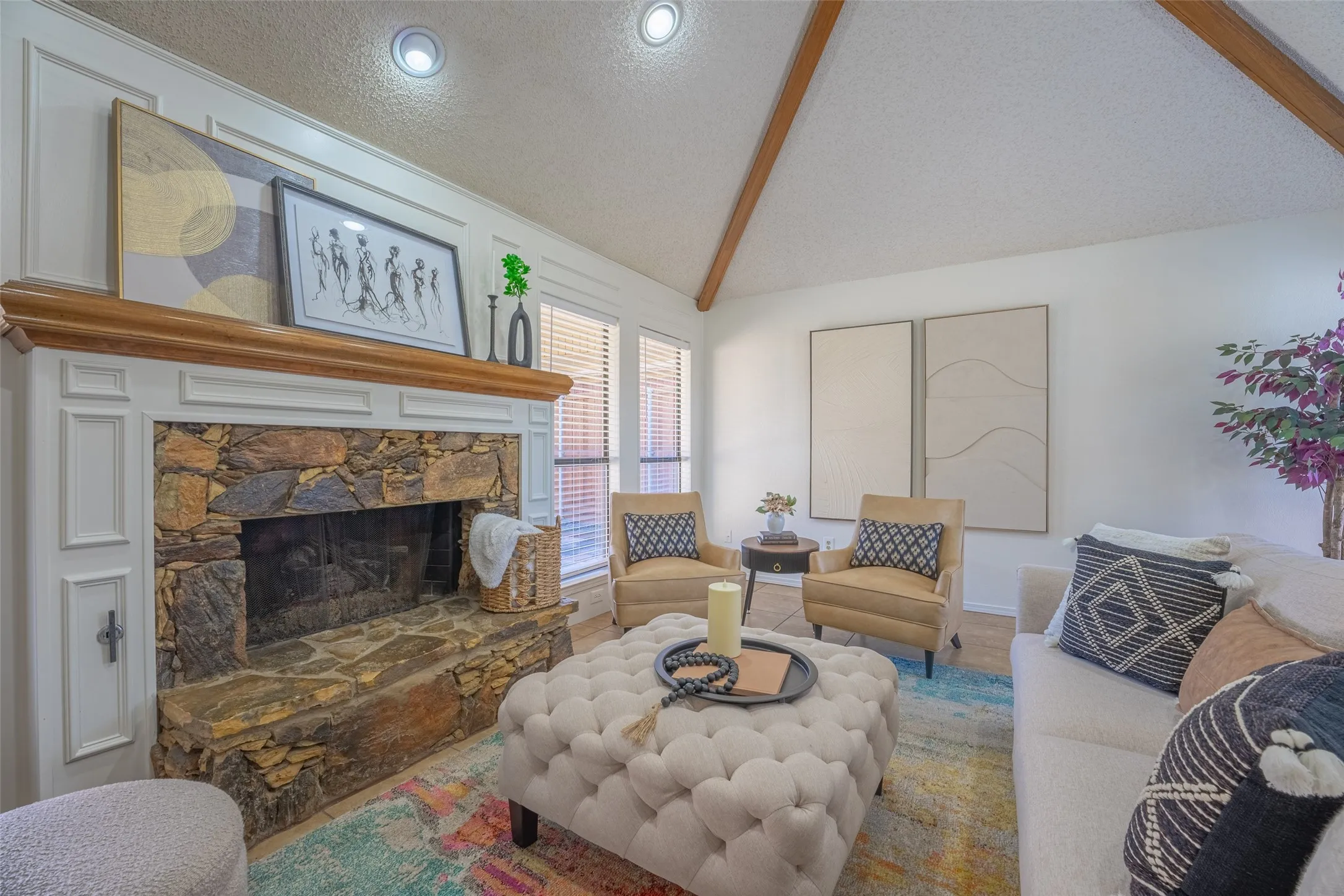 Stone fireplace with wood mantel, vaulted ceiling with exposed beams, recessed lighting, and wall-mounted windows