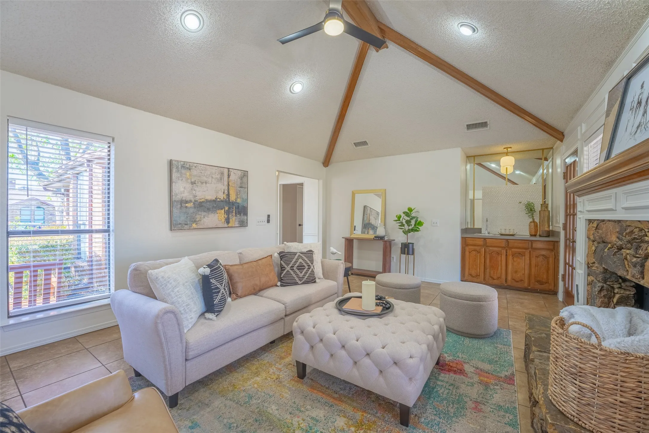 Vaulted ceiling with exposed wood beams and recessed lighting