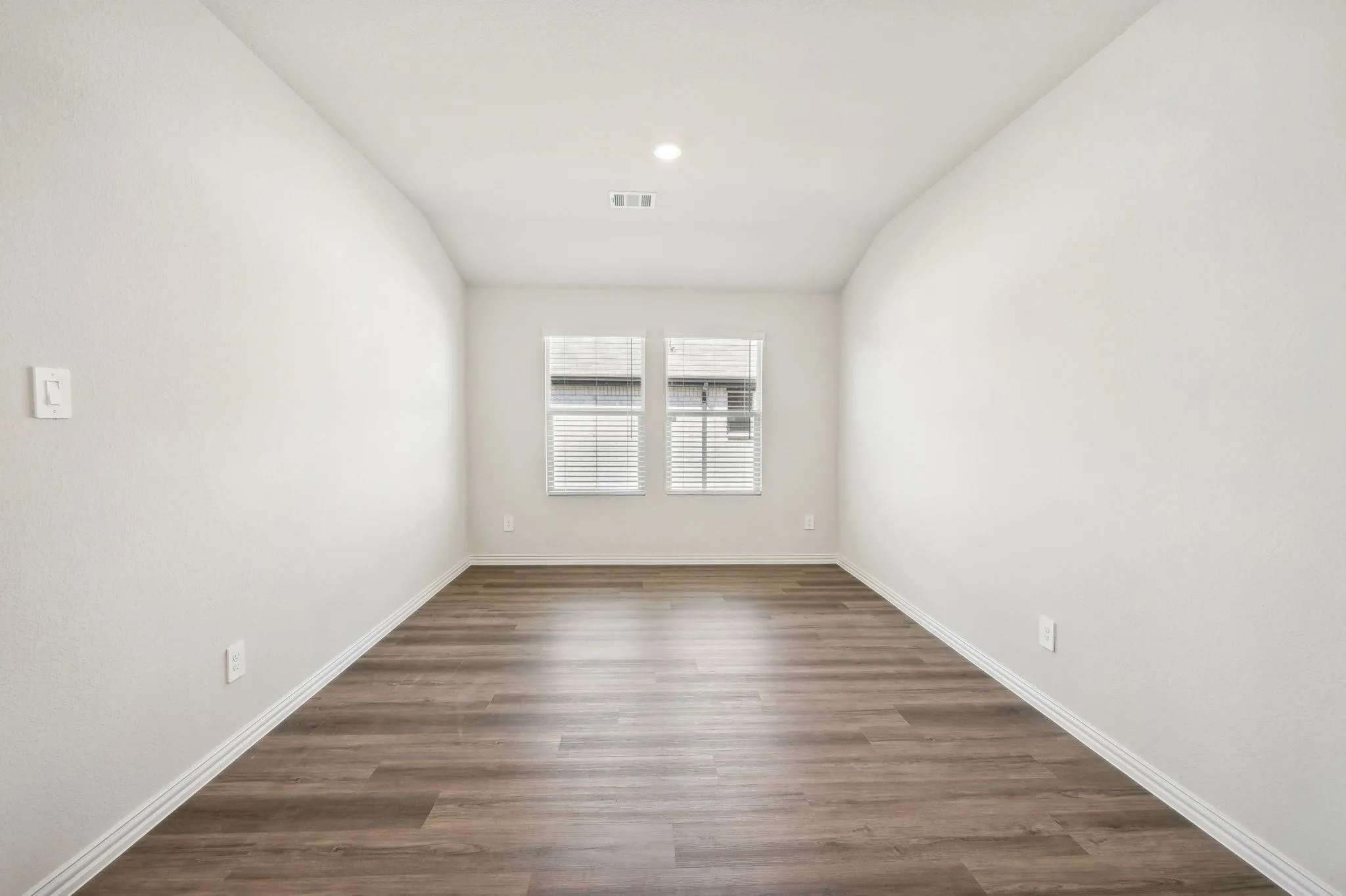 Spare room with visible vents, dark wood finished floors, and baseboards